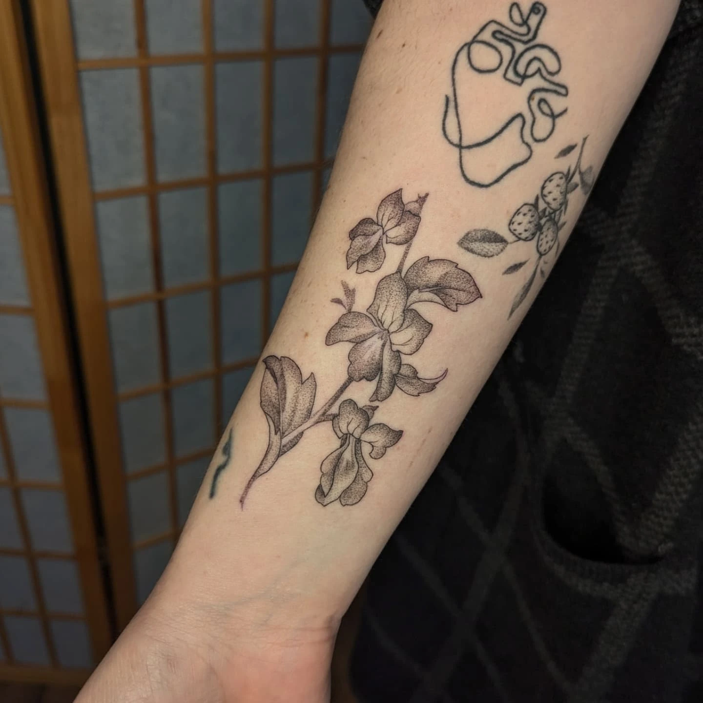 Orchid and leaves black and grey tattoo on the forearm by Jeanine, Providence, Rhode Island