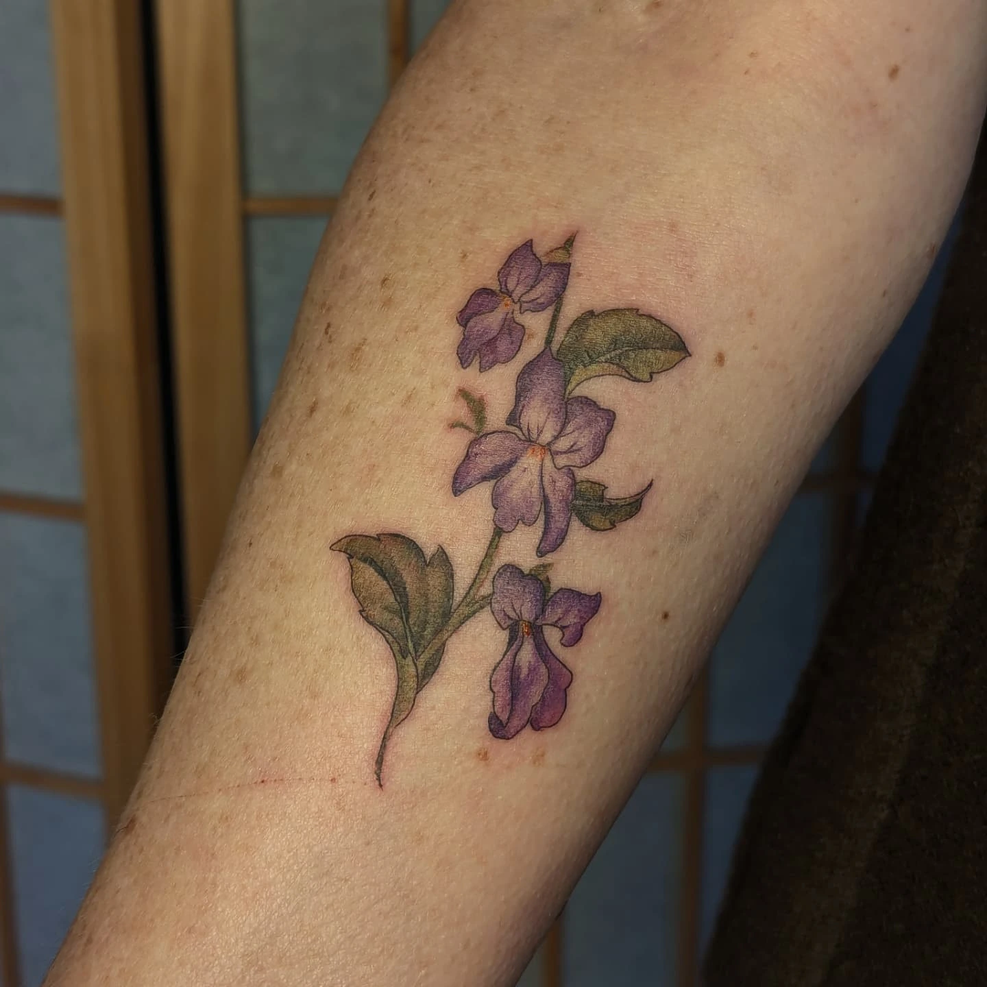 Purple flowers realism tattoo on the forearm by Jeanine, Providence, Rhode Island