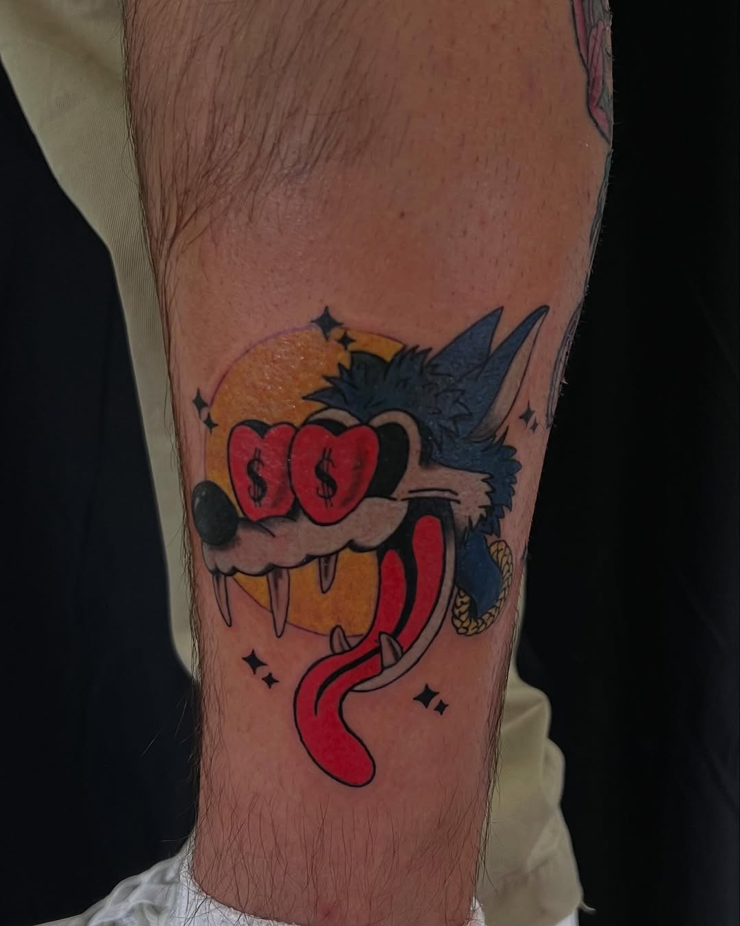 Wolf head with dollar sign eyes American traditional tattoo on the forearm by Stefany🩸