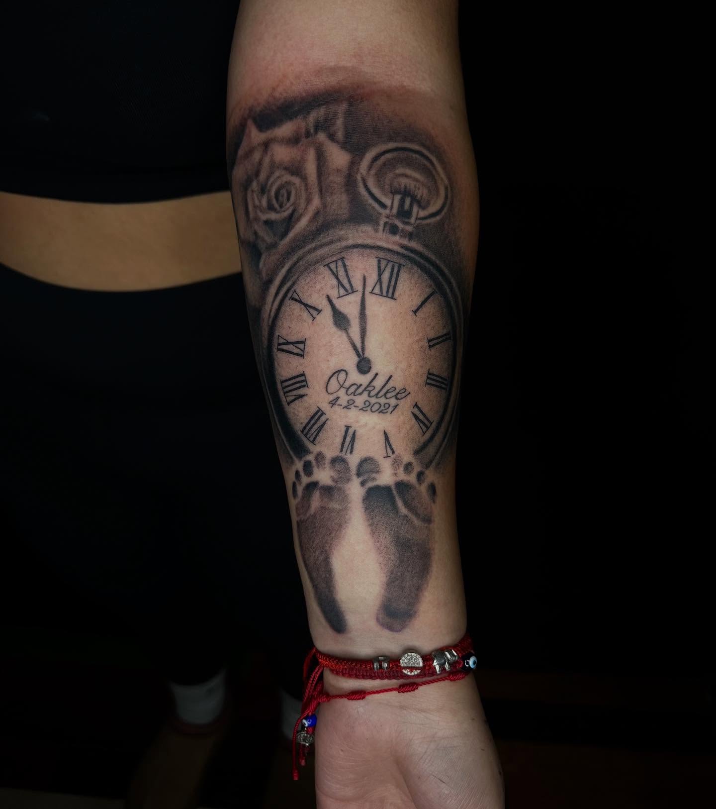 Clock with footprints realism tattoo on the forearm by Jay Morales