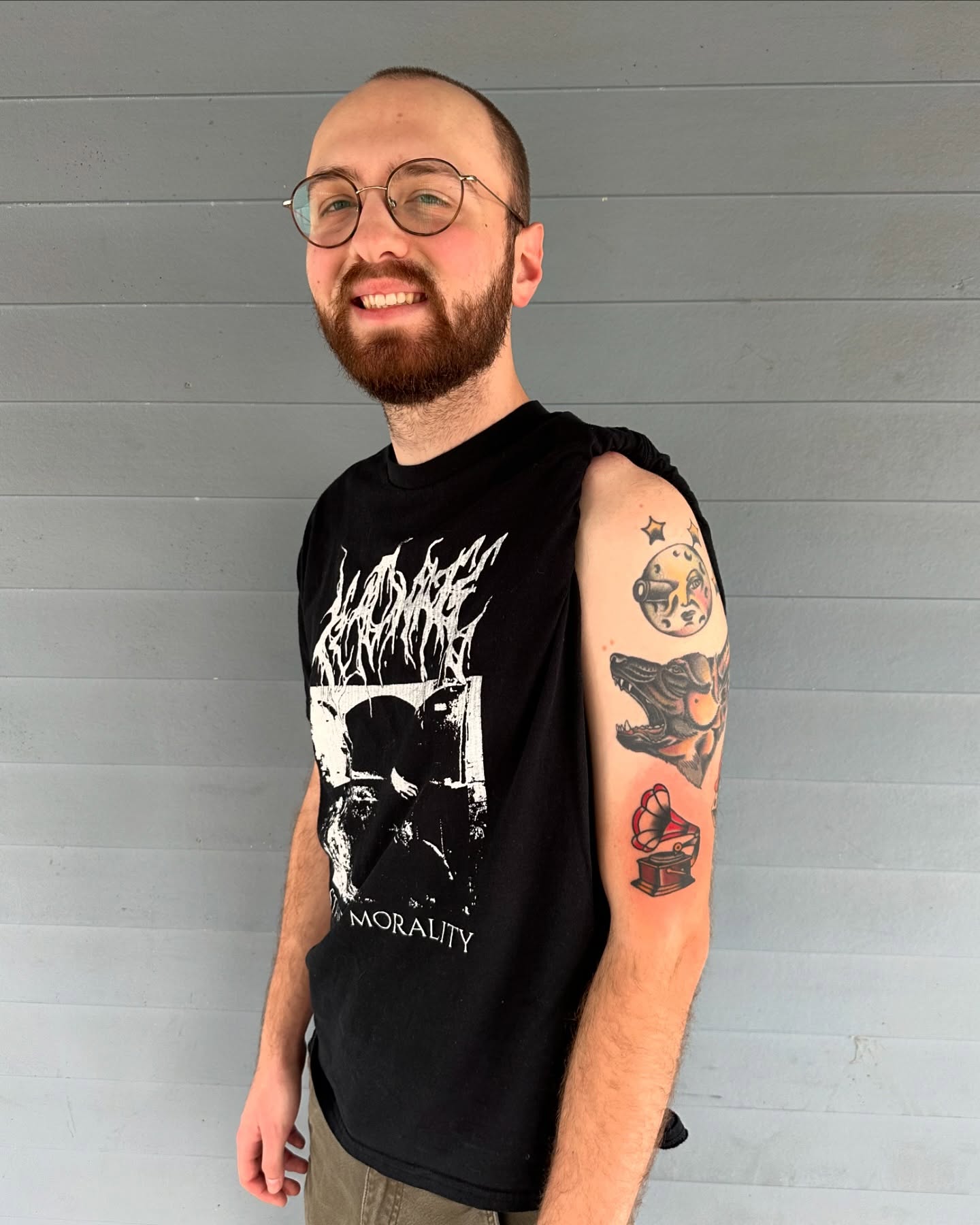 Gramophone black and grey tattoo on the upper arm by Michael Williams