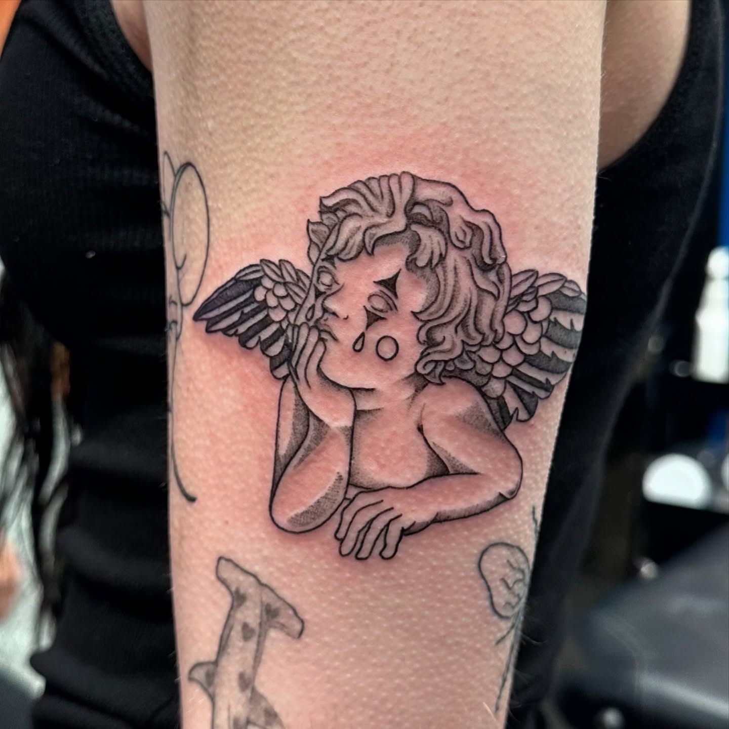 Cherub black and grey tattoo on the forearm by Shannon, Cincinnati, Ohio