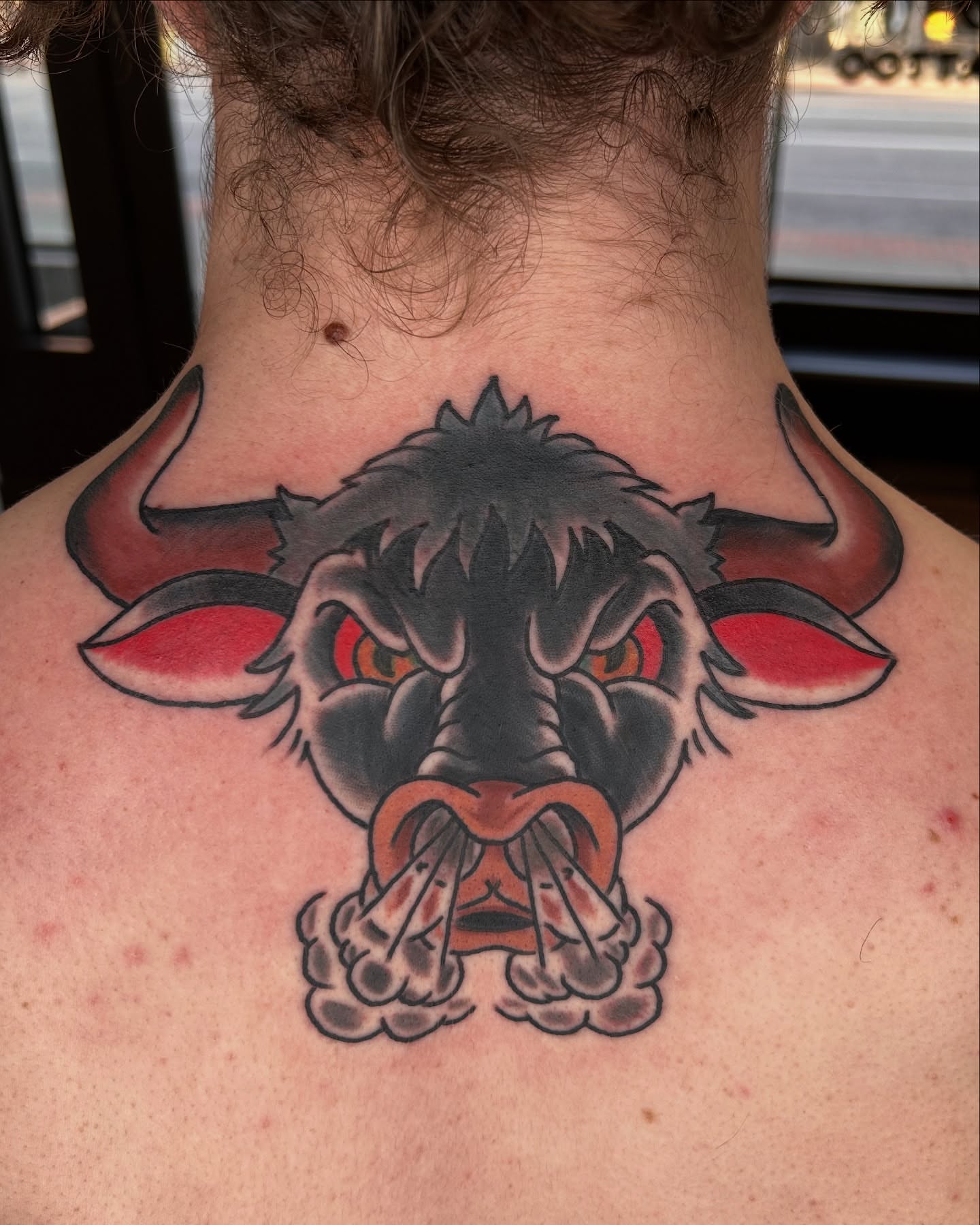 Bull American traditional tattoo on the neck by Alex Fannin