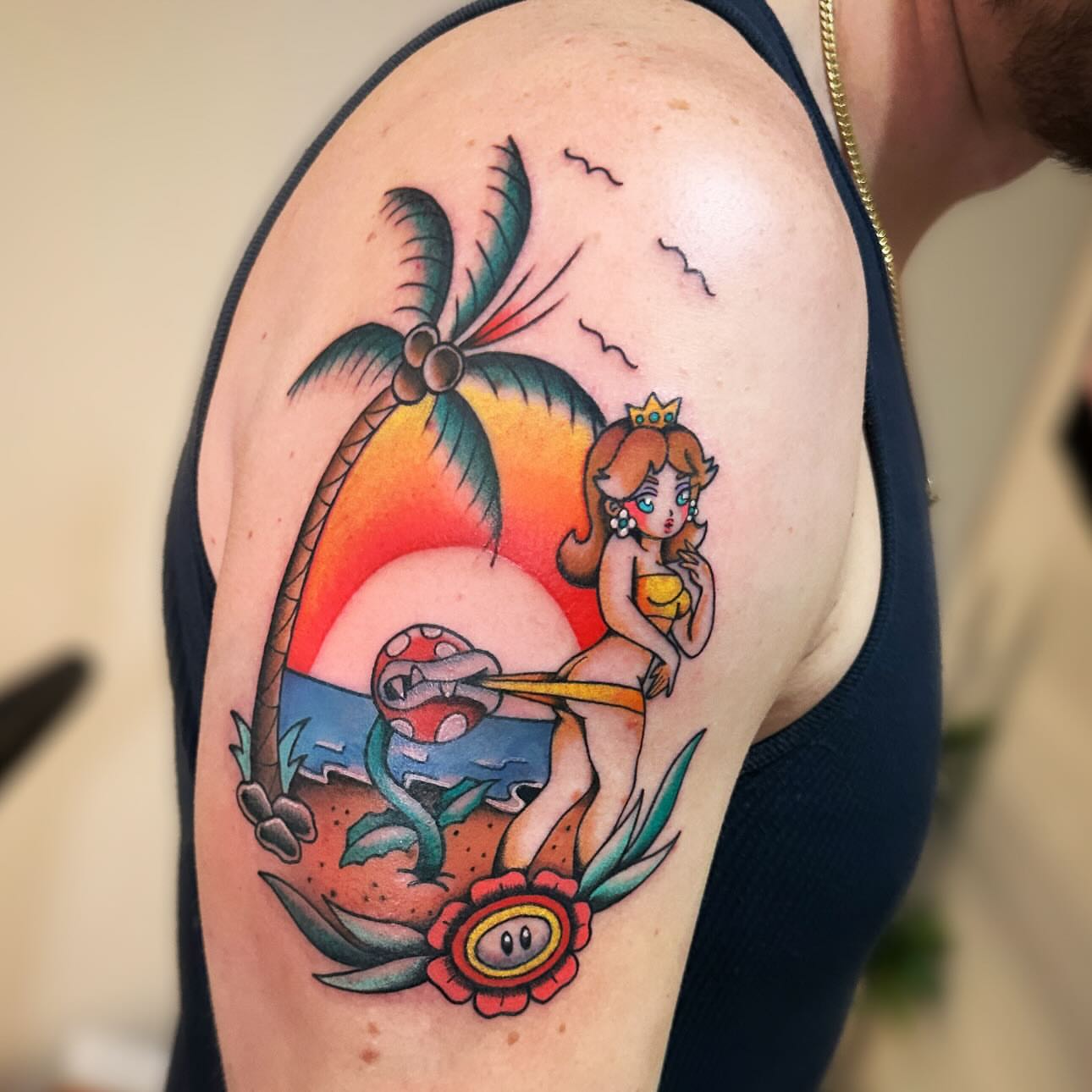 Beach scene with princess American traditional tattoo on the shoulder by Annah Lea