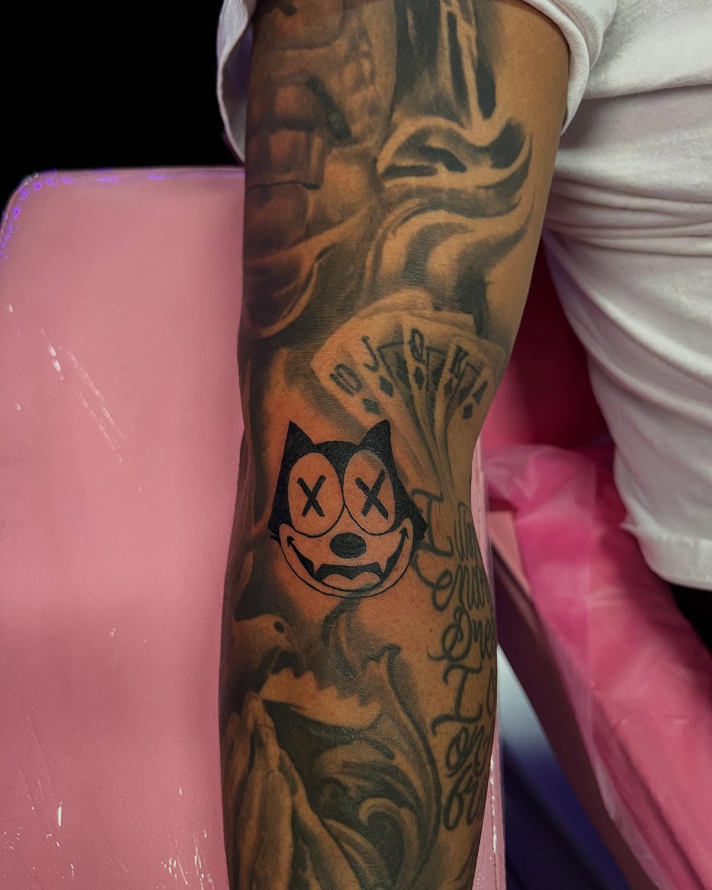Cat black and grey tattoo on the forearm by Jasmin Lozano