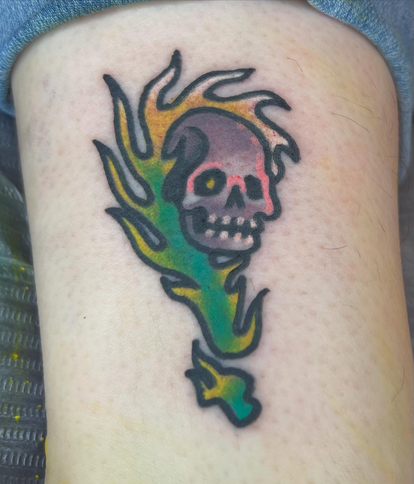 Flaming skull American traditional tattoo on the thigh by Will Eagle