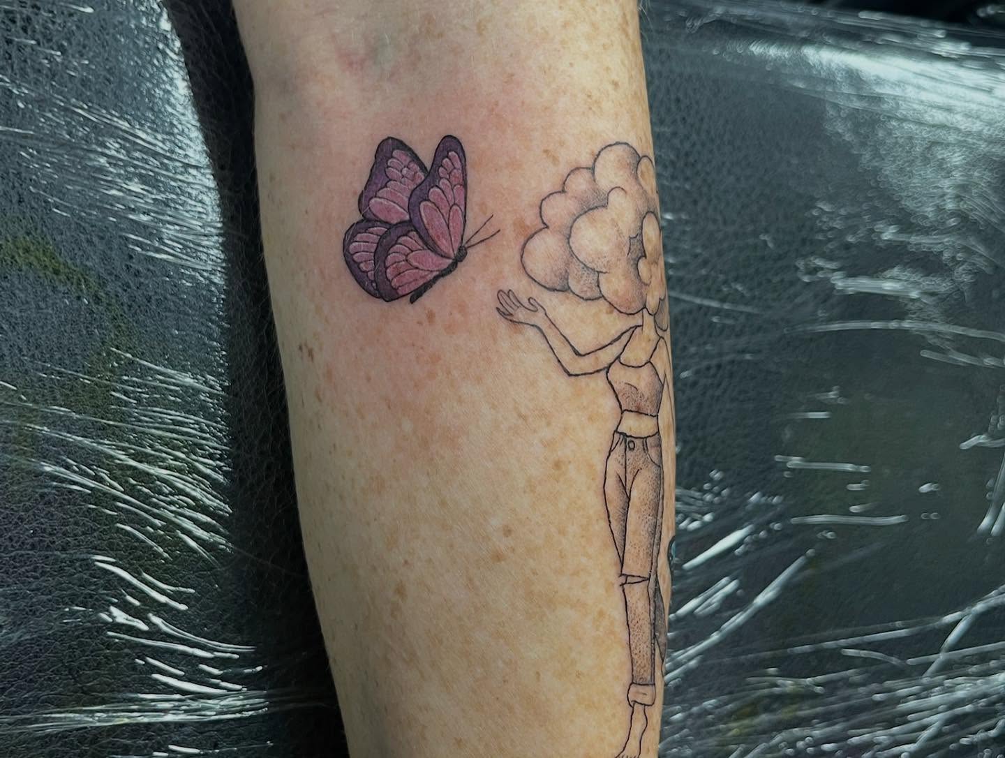 Butterfly and cloud dotwork tattoo on the forearm by Tattoos by Gina Palladino
