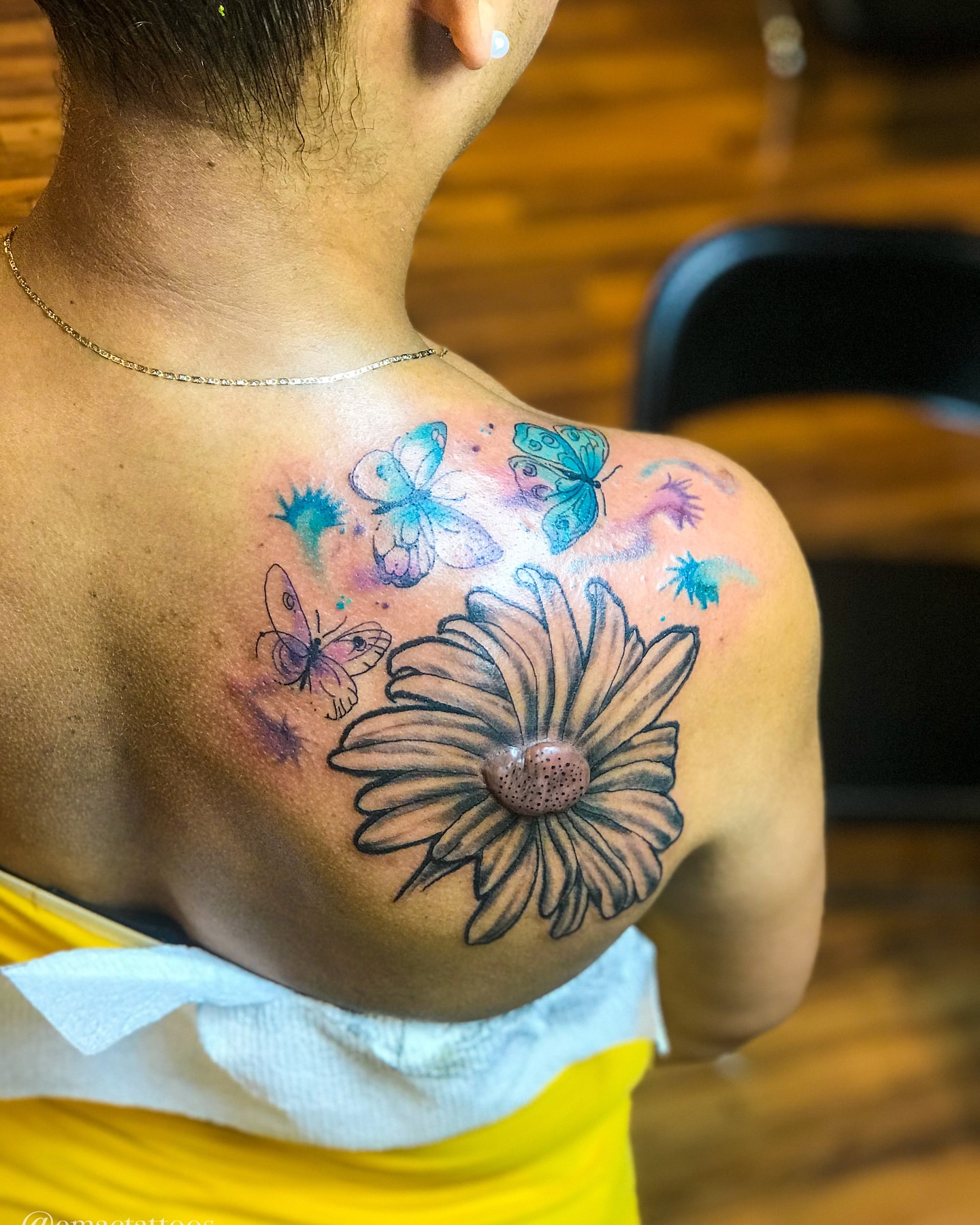 Flower and butterflies watercolor tattoo on the shoulder by Emac, Baltimore, Maryland