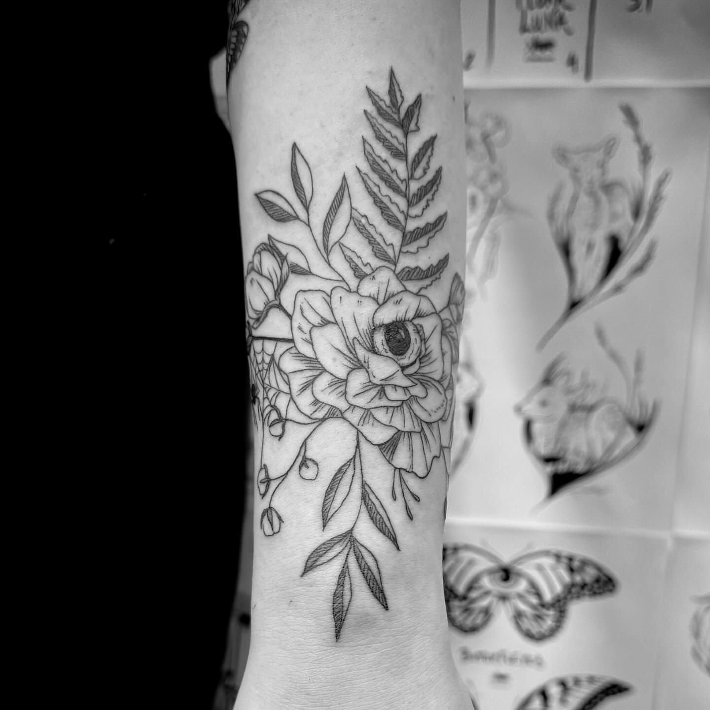 Flower and leaves black and grey tattoo on the forearm by Christen Wolfe CA Tattooer