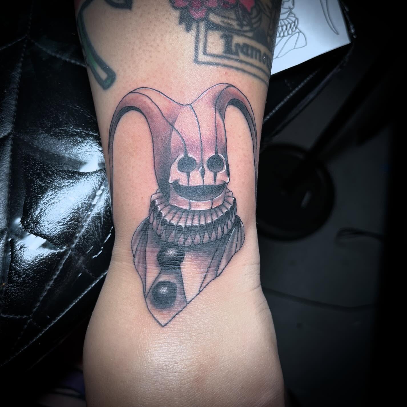 Jester skull realism tattoo on the forearm by alexandra