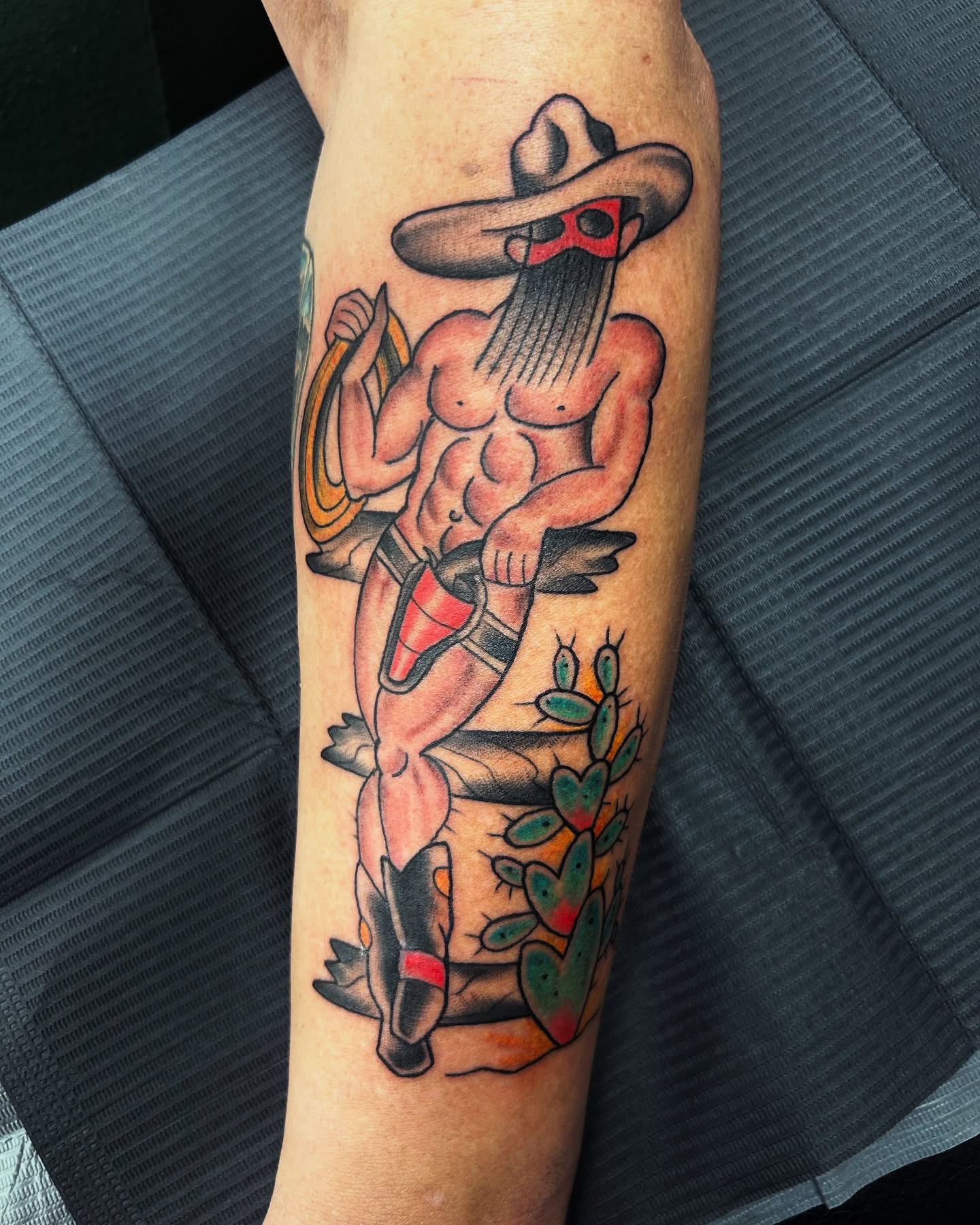 Muscle man with sombrero American traditional tattoo on the forearm by Patricia Cunningham