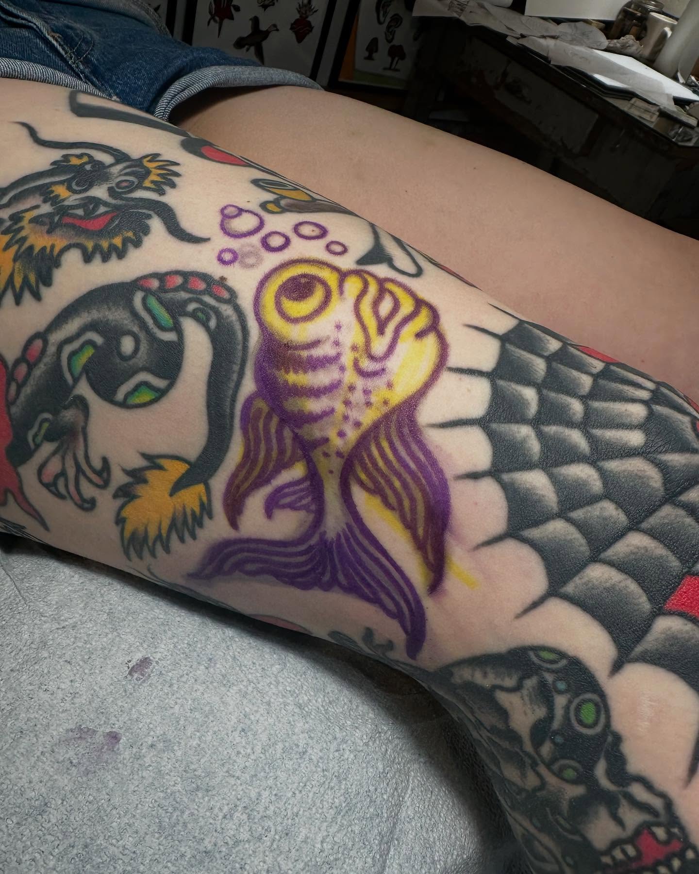 Koi fish American traditional tattoo on the thigh by San Diego tattoo artist