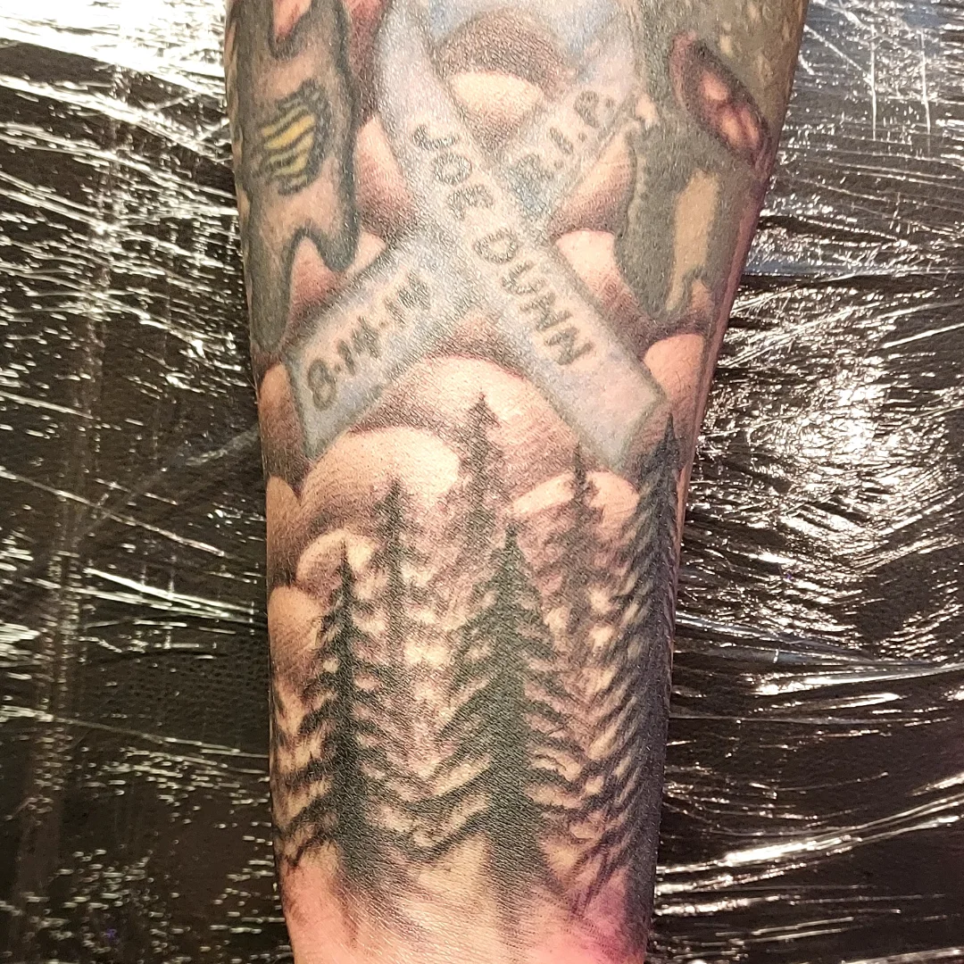Hand holding money realism tattoo on the forearm by Dave Johnson, Billings, Montana
