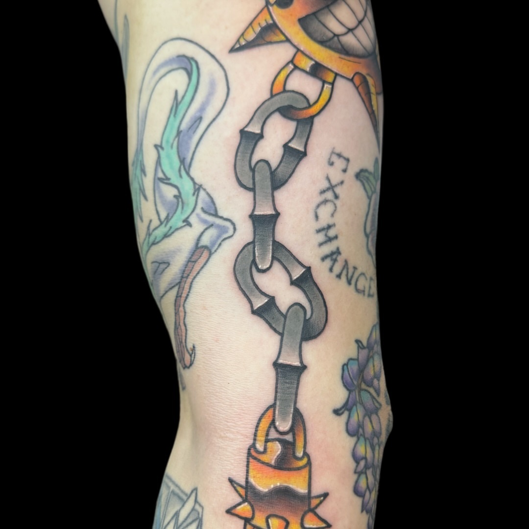 Chain and padlock American traditional tattoo on the forearm by Victor Campos