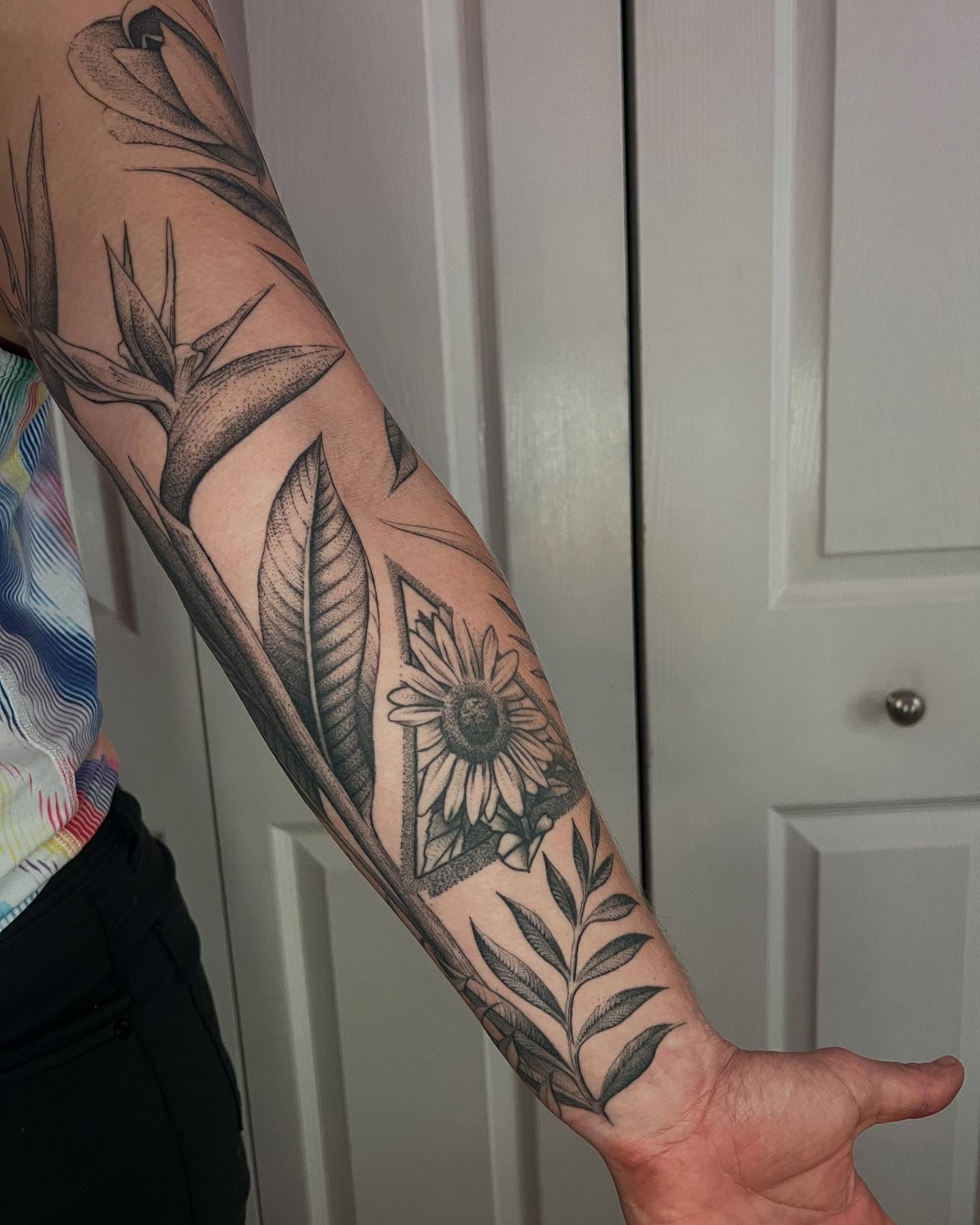 Sunflower and leaves realism tattoo on the forearm by Natasha