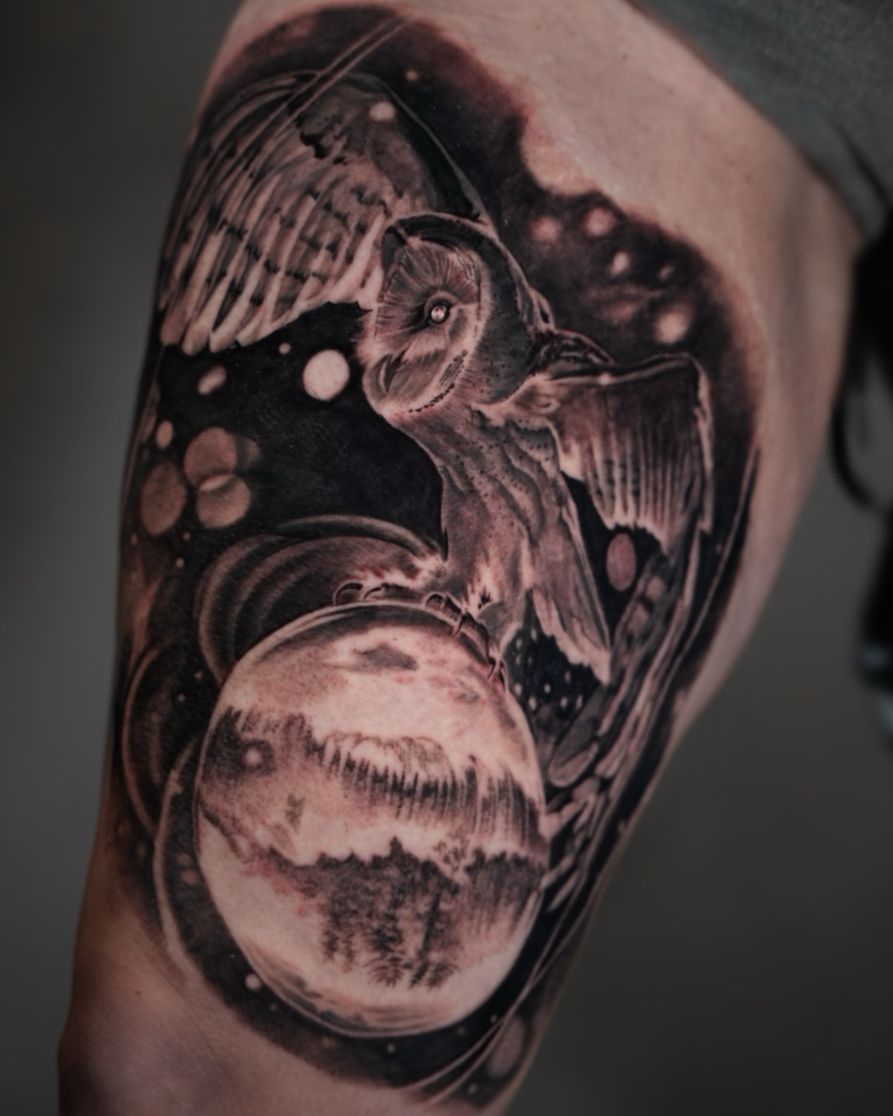 Owl and planet realism tattoo on the forearm by Bailey Lemus
