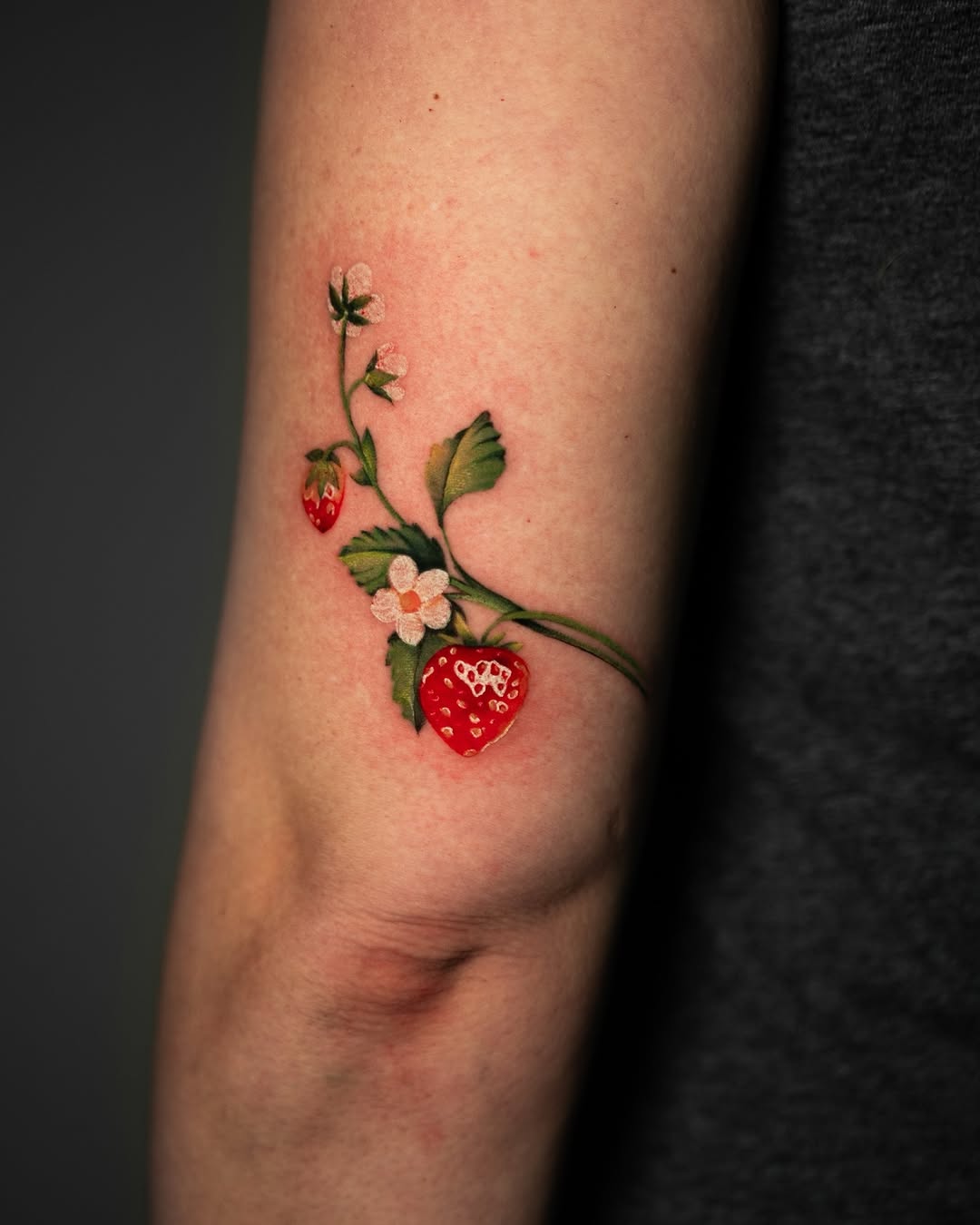 Strawberry plant with flowers neo-traditional tattoo on the forearm by Jen- San Antonio tattoo artist