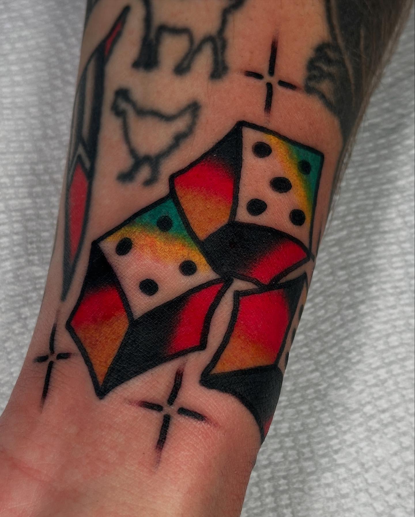 Dice geometric tattoo on the forearm by Steve Pearson