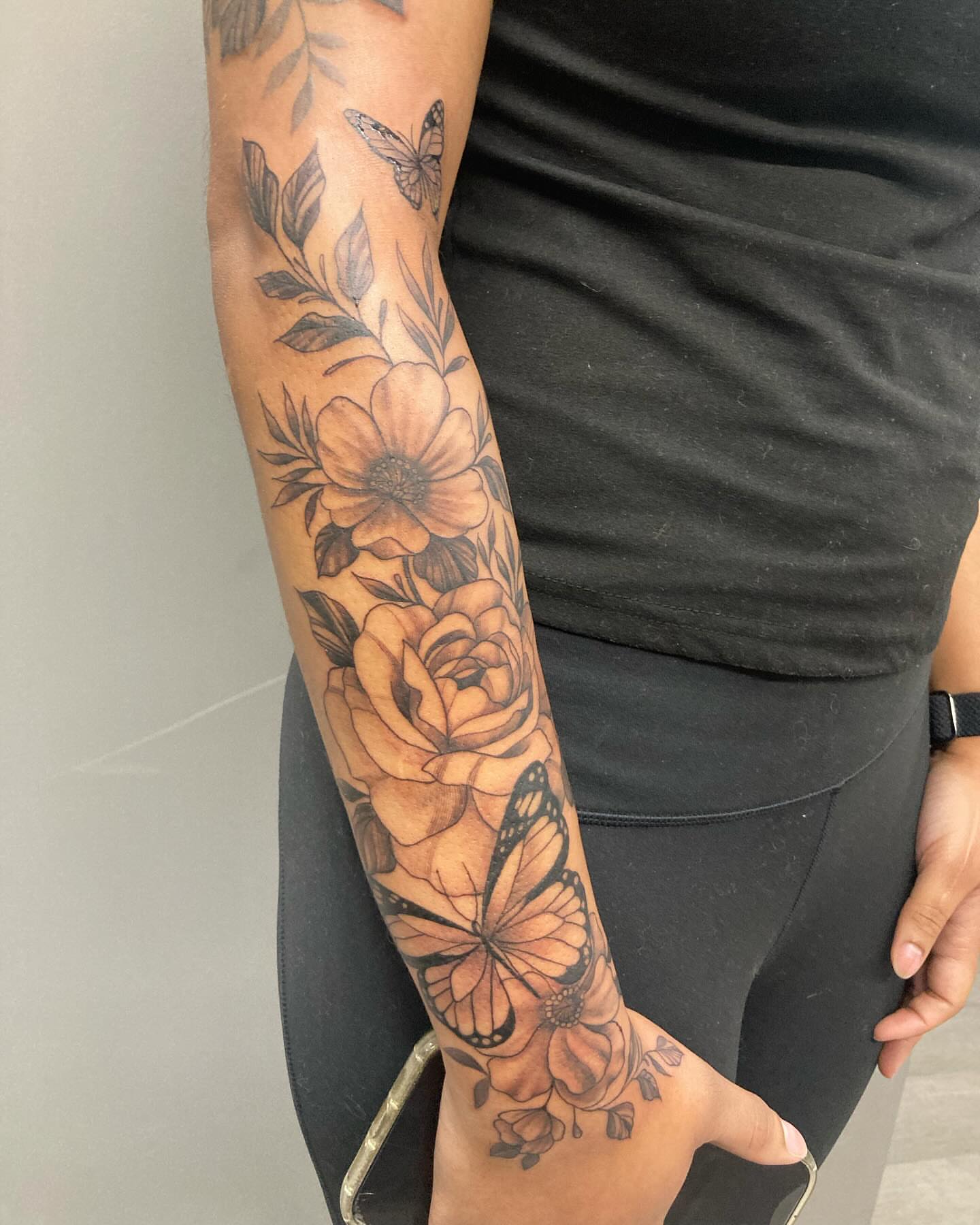 Flowers and butterflies black and grey tattoo on the forearm by Detroit Tattoo Artist