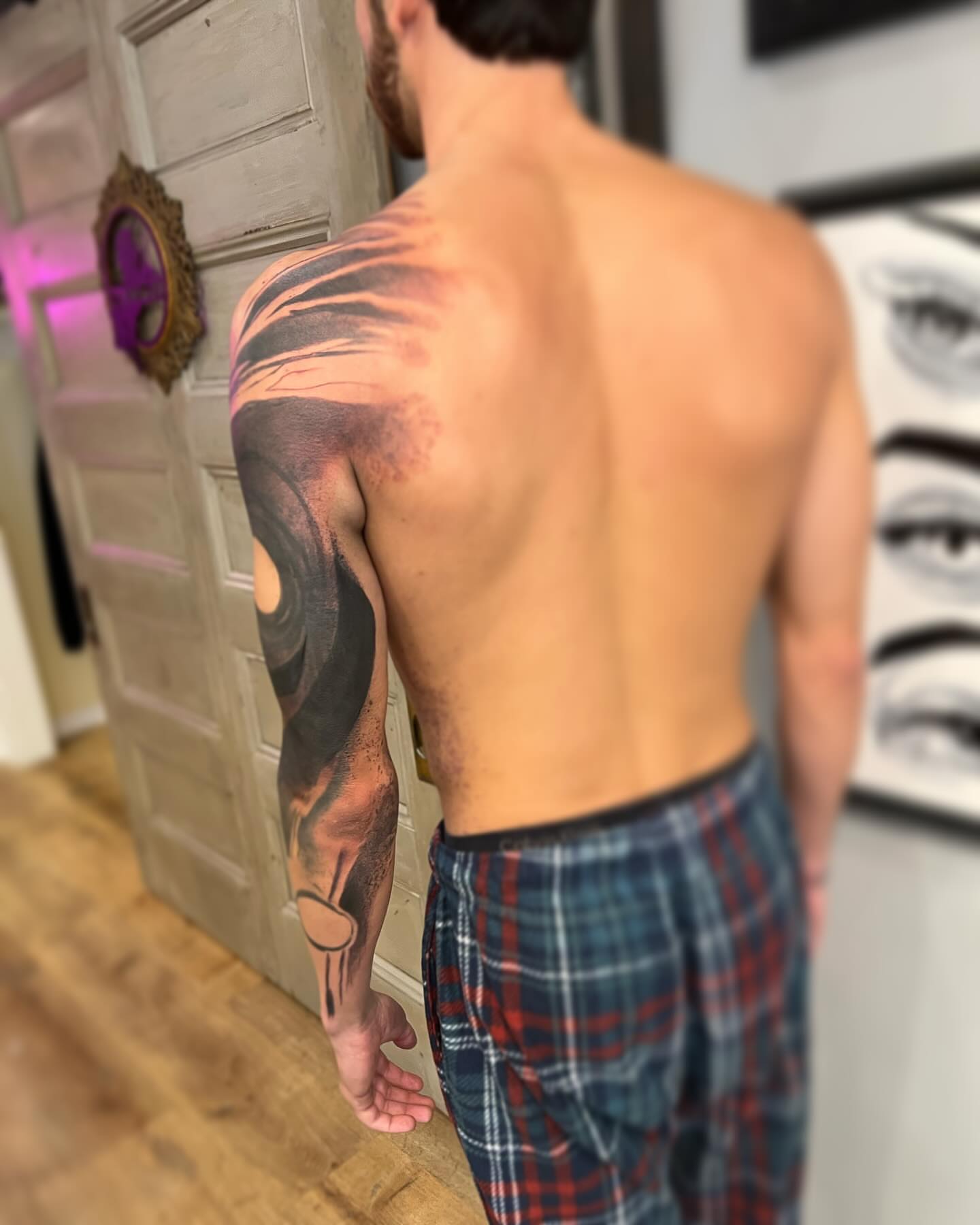 Abstract spiral dotwork tattoo on the upper arm by Rizzie D'Alterio