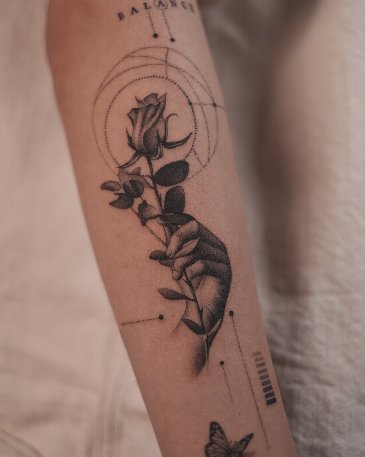 Rose and hand dotwork tattoo on the forearm by Oleksandr Moroz