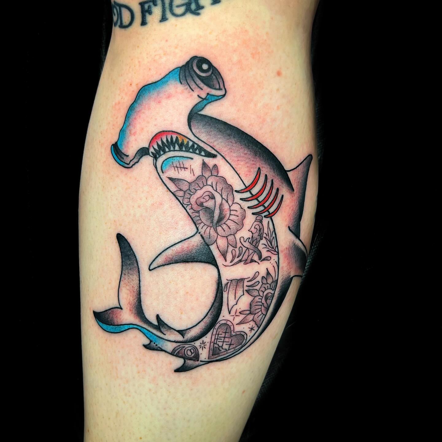 Shark with floral American traditional tattoo on the forearm by @sloanxkettering