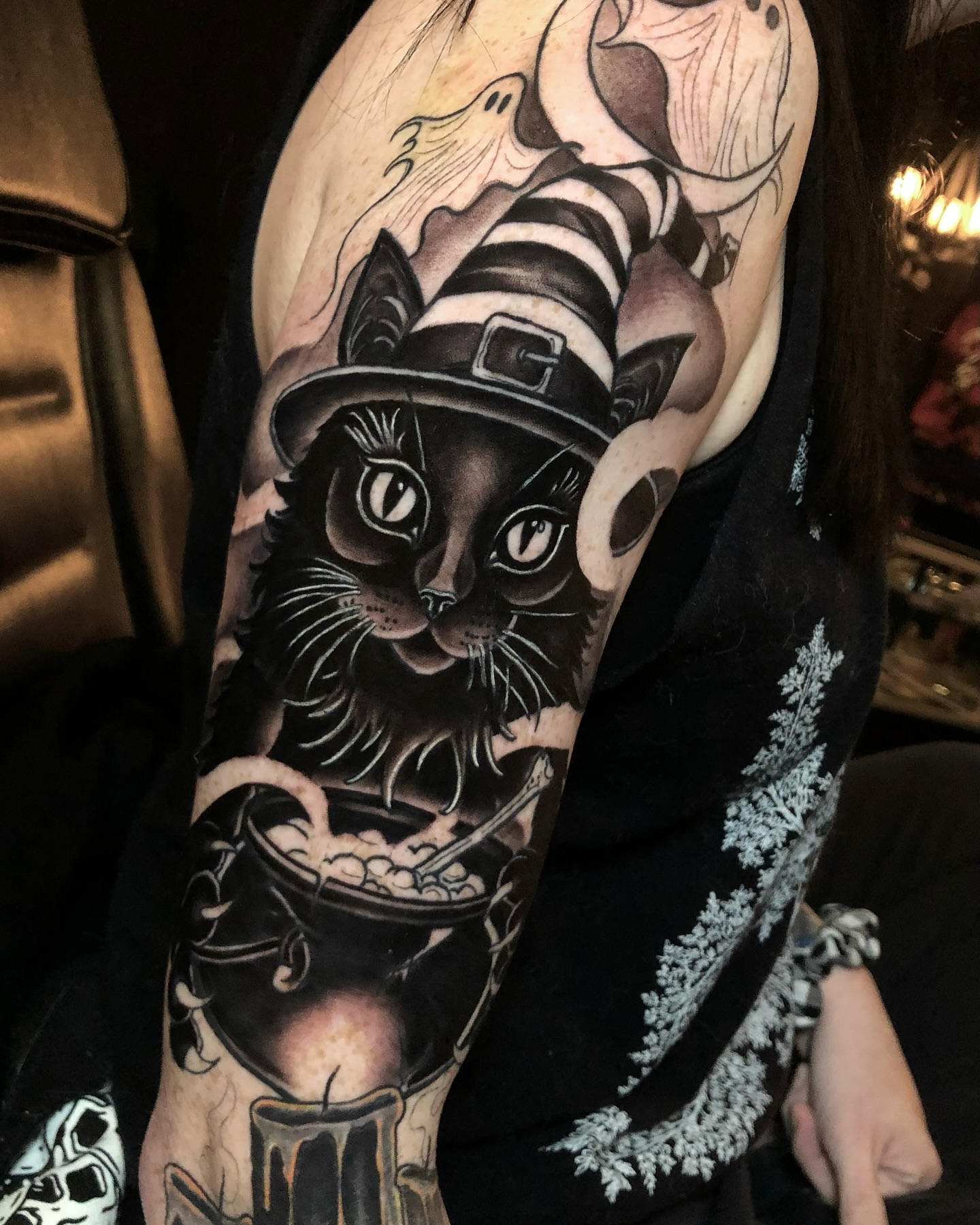 Cat witch dark realism tattoo on the forearm by Melissa Brown