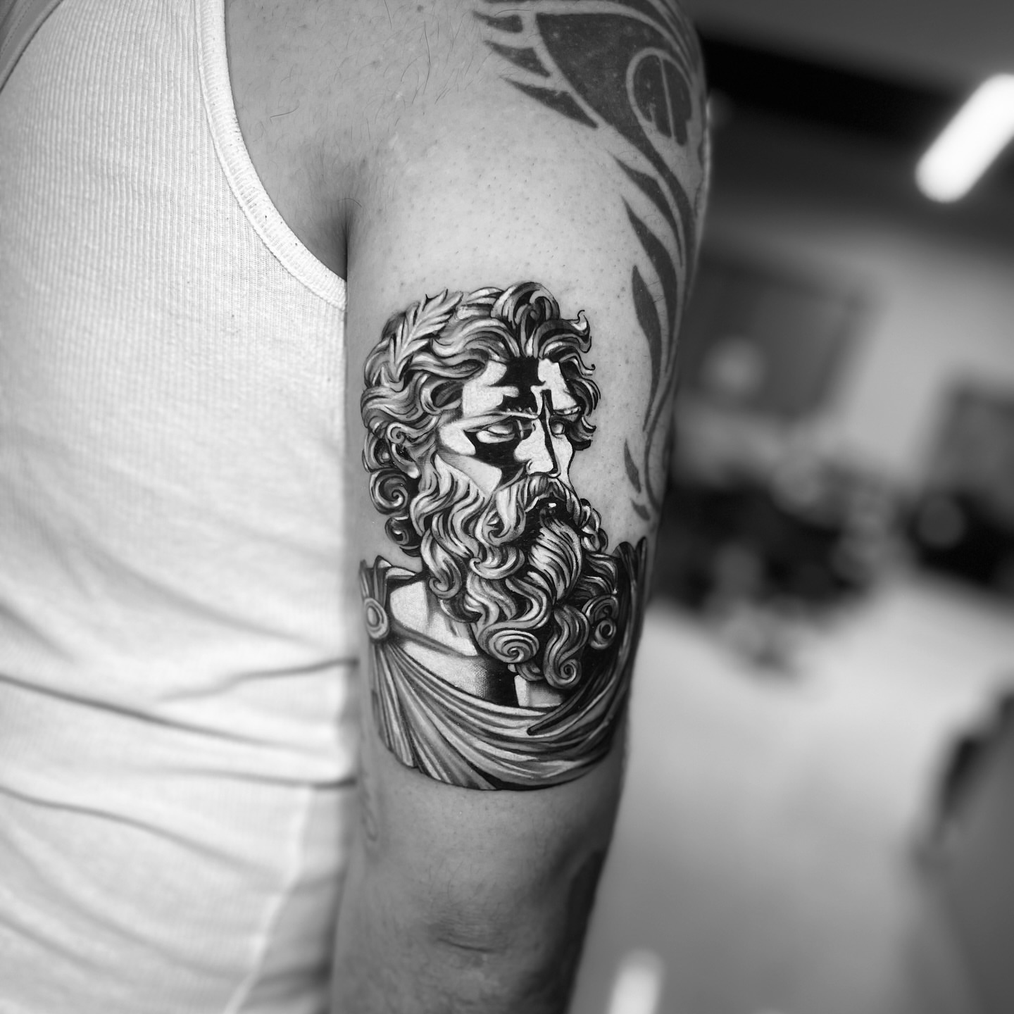 Bearded man black and grey tattoo on the forearm by Bay Area Tattoo Artist