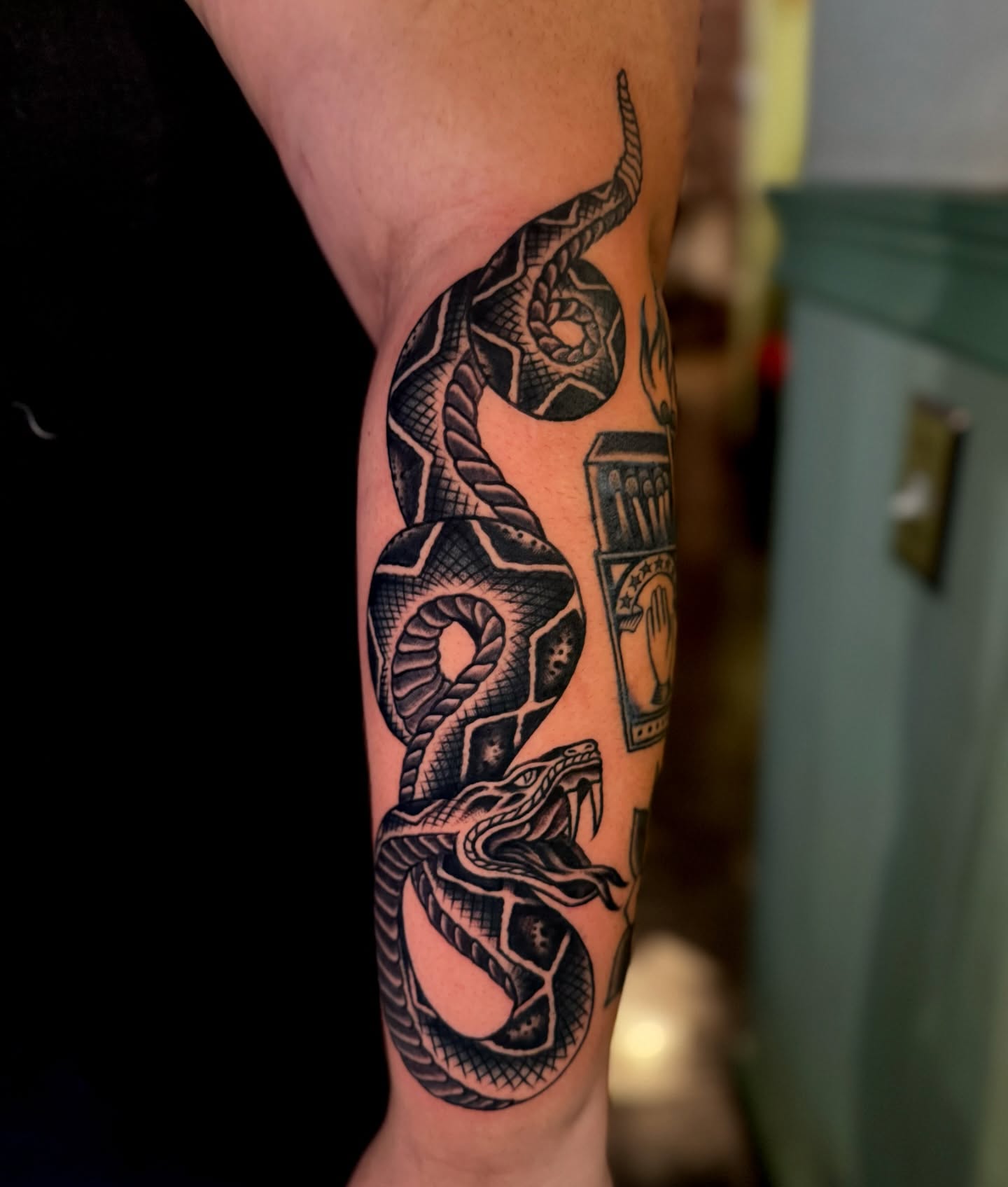 Snake black and grey tattoo on the forearm by Pavel