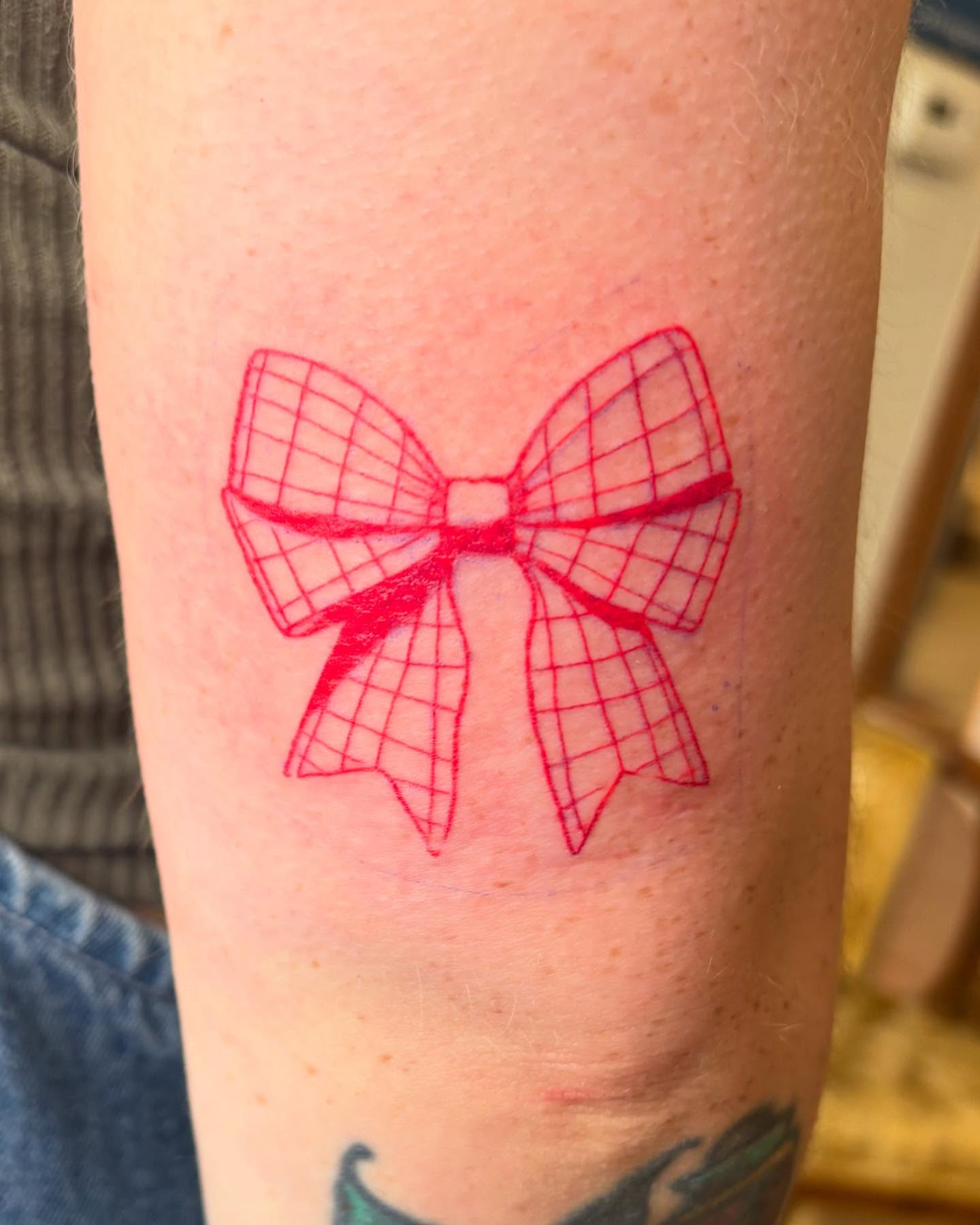 Bow geometric tattoo on the forearm by Anna Kathleen, Des Moines, Iowa