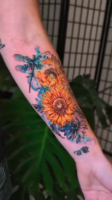 Sunflowers and dragonflies realism tattoo by Colorful Tattoos by Cody Dean