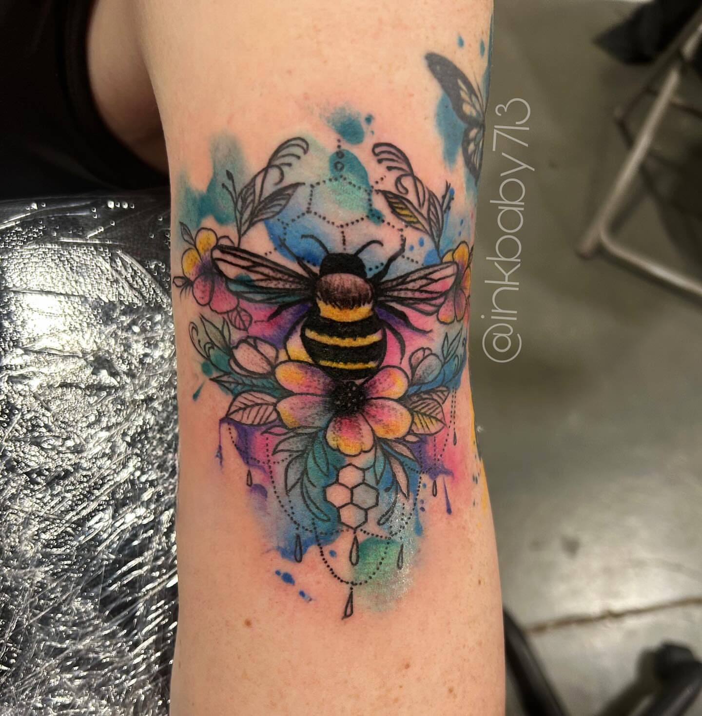 Bee and flowers watercolor tattoo on the forearm by Ayanna Luna