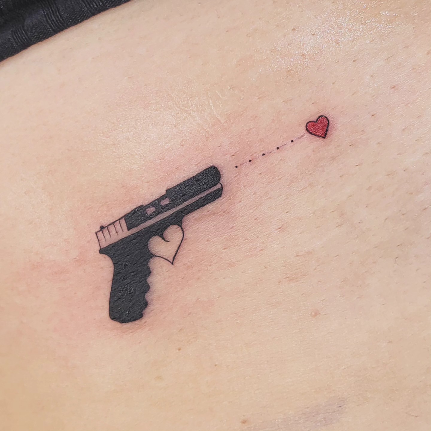 Gun with heart dotwork tattoo on the shoulder by Brenda Juarez - Tattoo Artist
