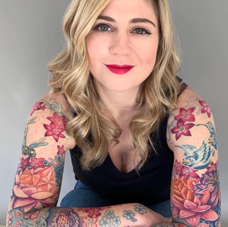 Floral and bird American traditional tattoo on the upper arm by Phil Robertson