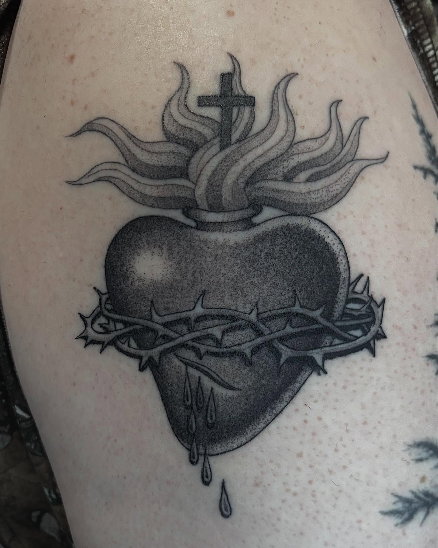 Heart with crown of thorns dotwork tattoo on the thigh by Jake Hodson, Nashville, Tennessee