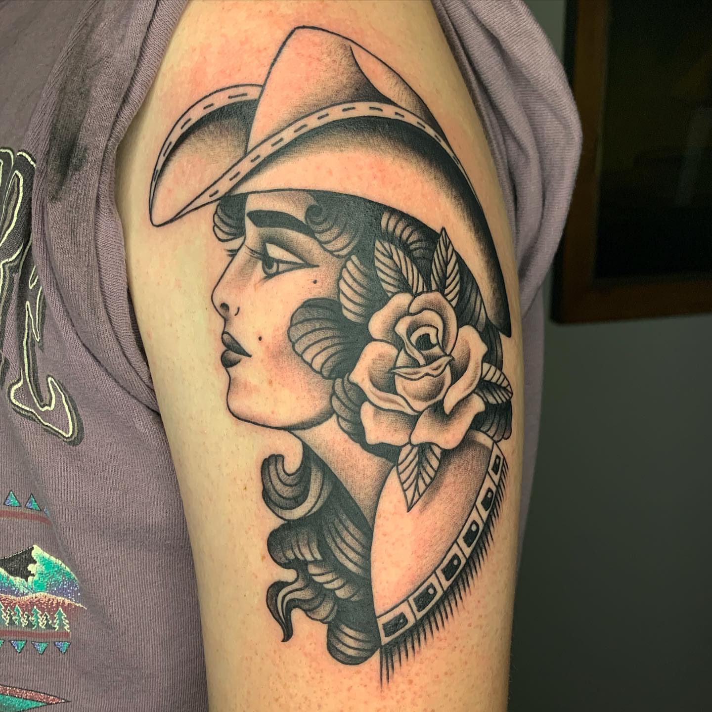 Woman with hat and rose American traditional tattoo on the shoulder by Jacob Deirfield, Circleville, Ohio