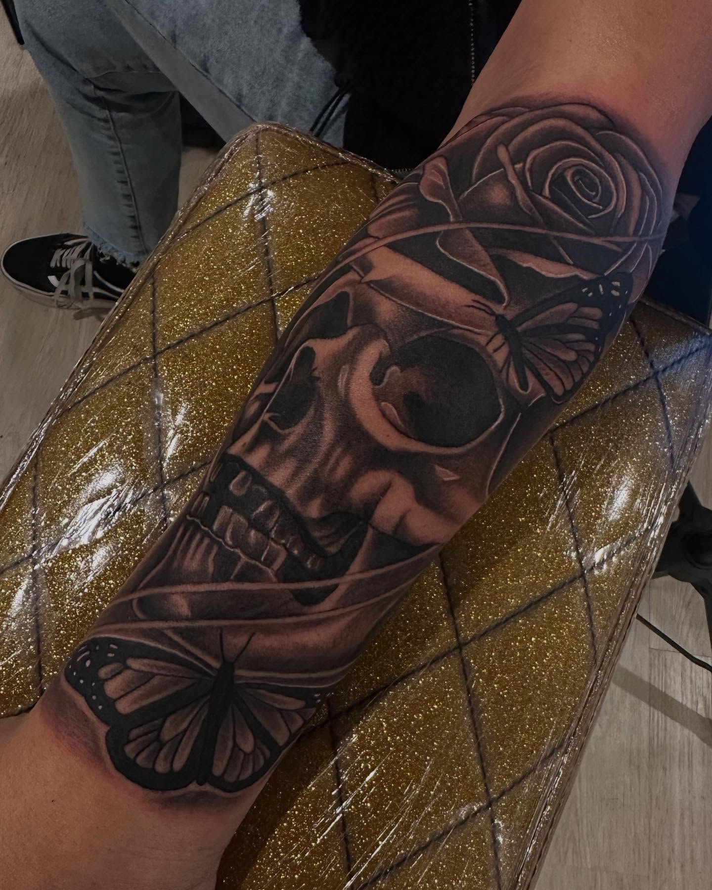 Skull and butterflies realism tattoo on the forearm by Bree Quirino