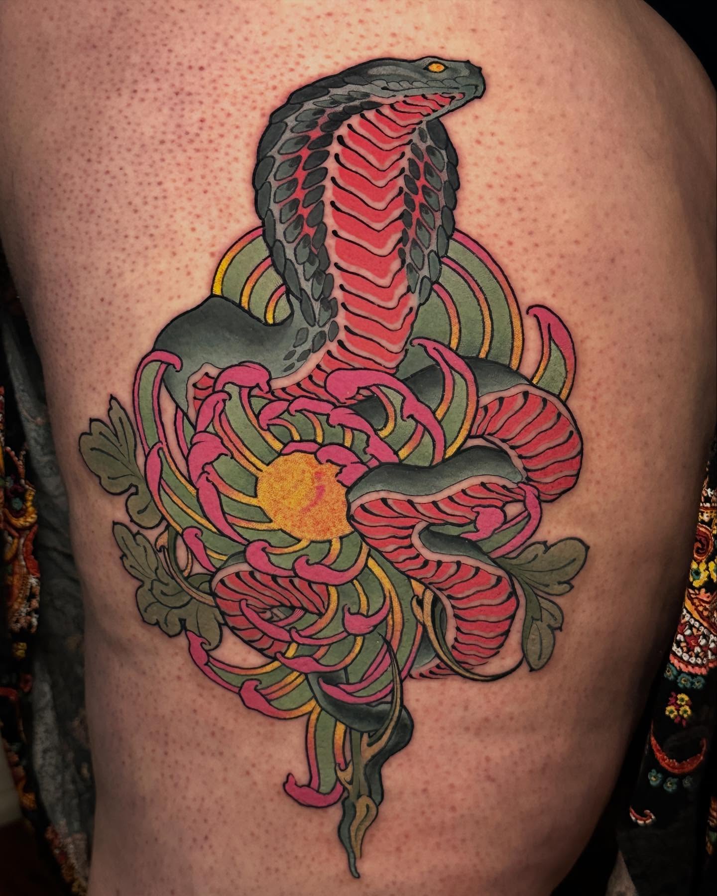 Snake and chrysanthemum American traditional tattoo on the shoulder by Claire Evans, San Francisco, California
