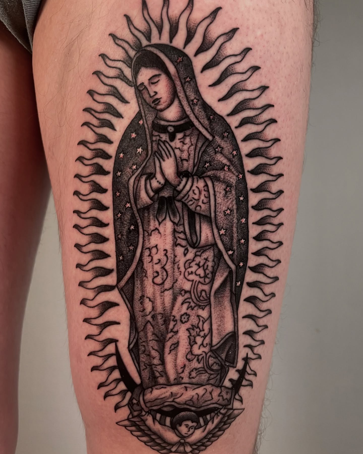 Our Lady of Guadalupe black and grey tattoo on the thigh by Vash