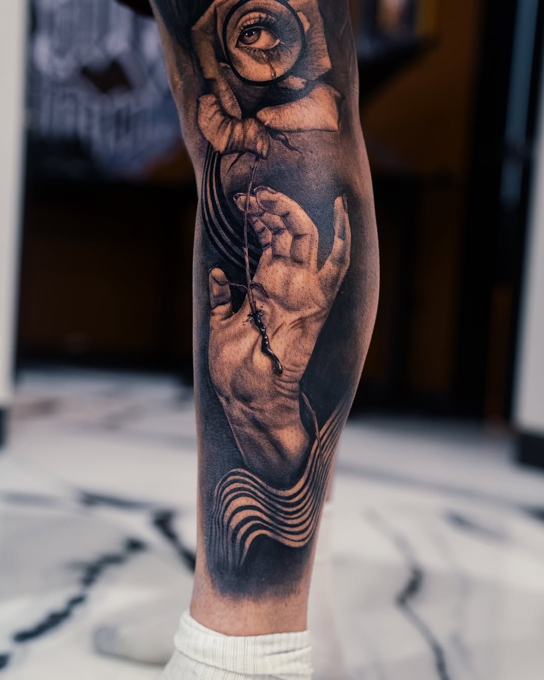 Eye in rose, hand, abstract waves surrealism tattoo on the forearm by Mia