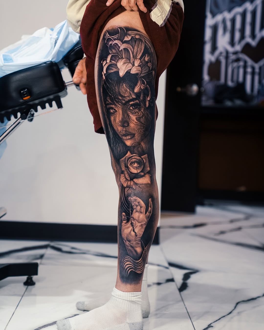 Woman's face, eye in rose, hand surrealism tattoo on the calf by Mia