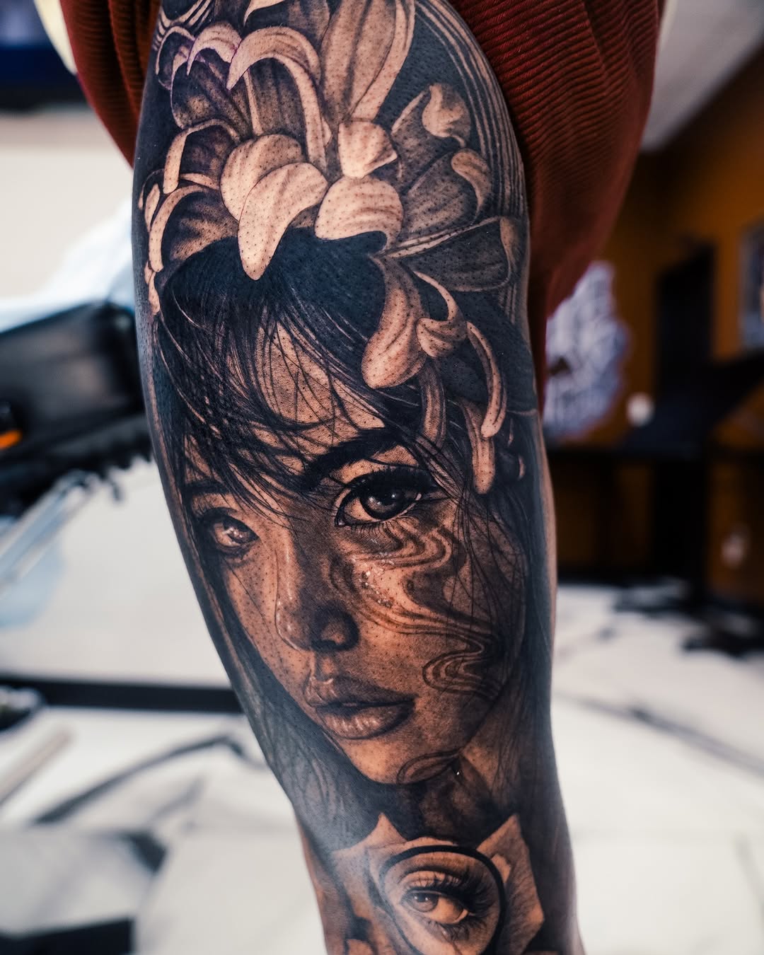 Portrait of a woman with flowers realism tattoo on the forearm by Mia