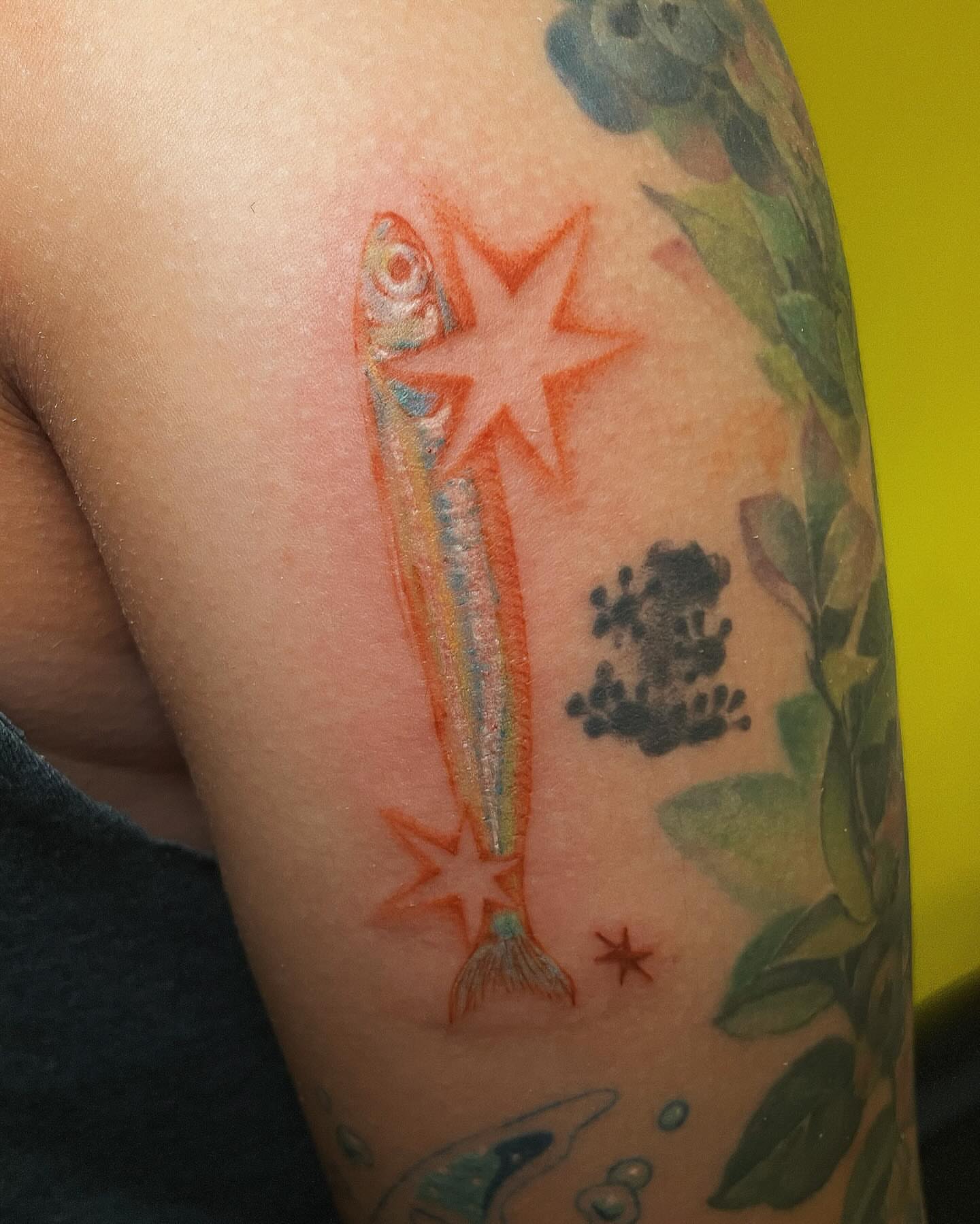 Shooting star fish new school tattoo on the upper arm by Echo