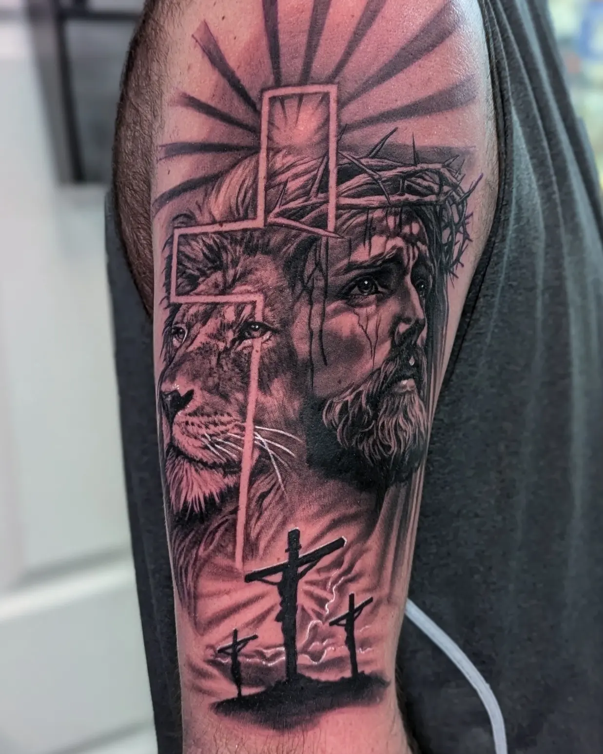 Lion and jesus realism tattoo on the forearm by Bethany Jane Tattoos