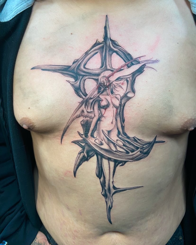 Cross with woman dark realism tattoo on the chest by Slade Nowicki