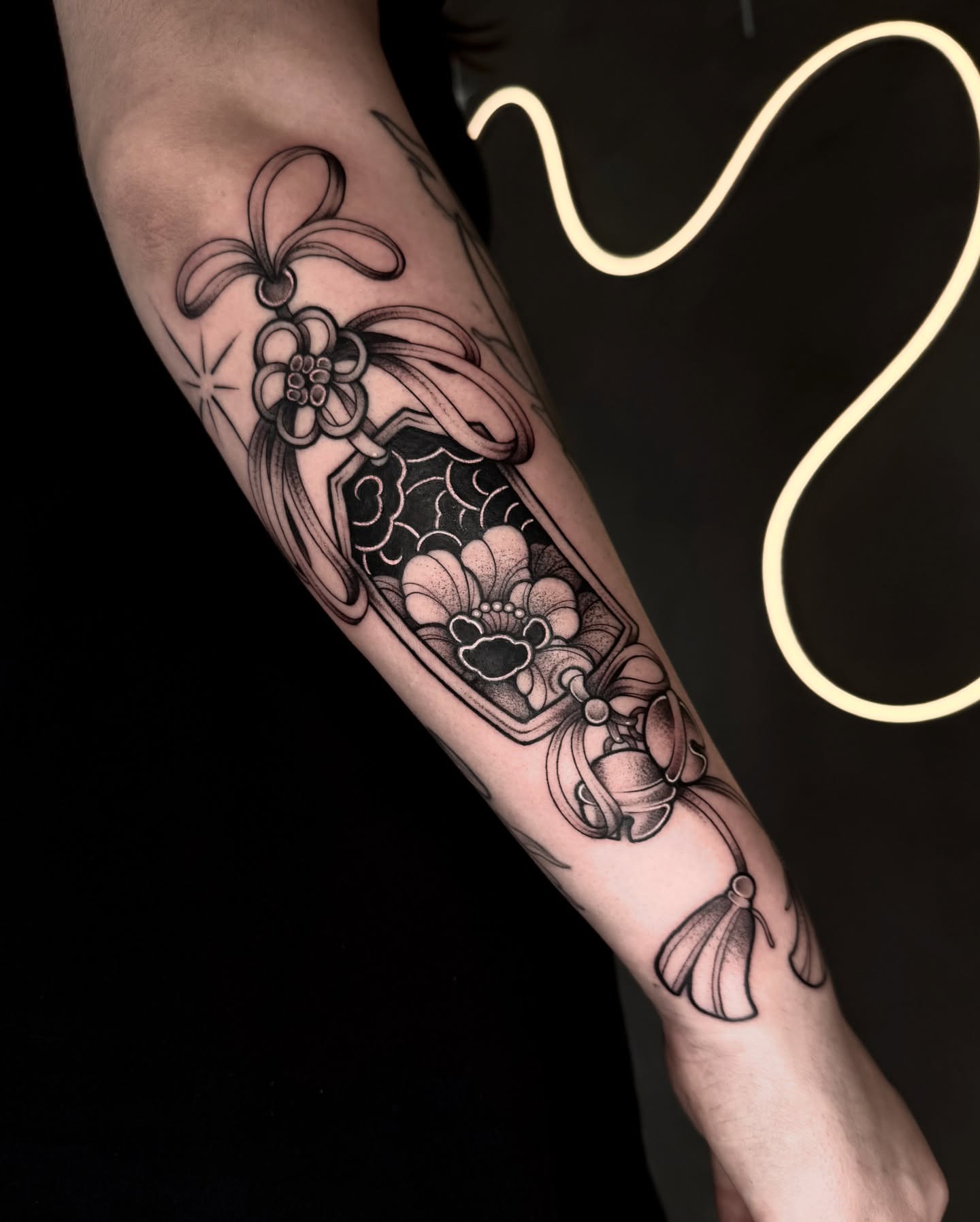 Floral arrangement black and grey tattoo on the forearm by Gabrieli Folha