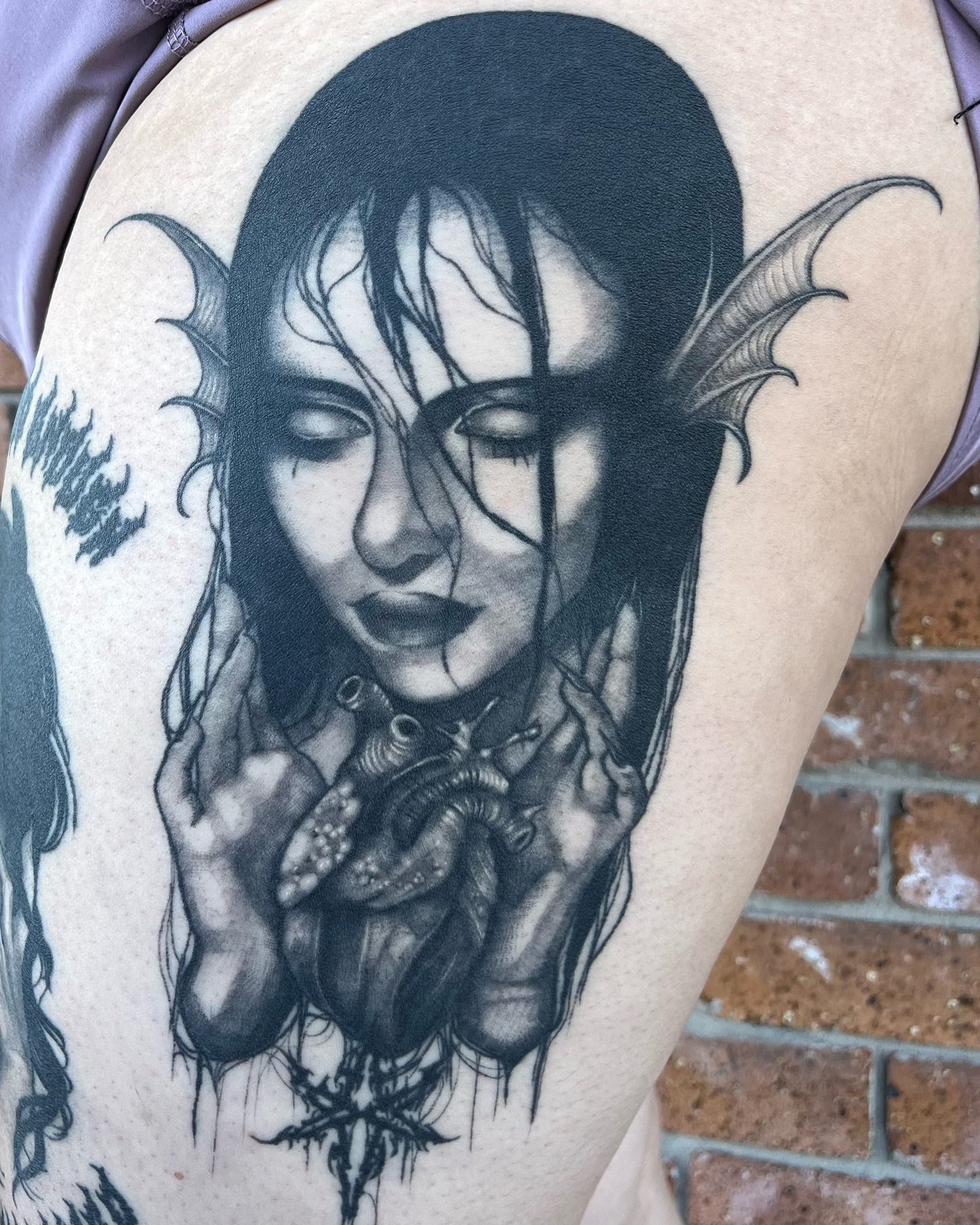 Woman with bat wings dark realism tattoo on the upper arm by Myla Jane, Houston, Texas