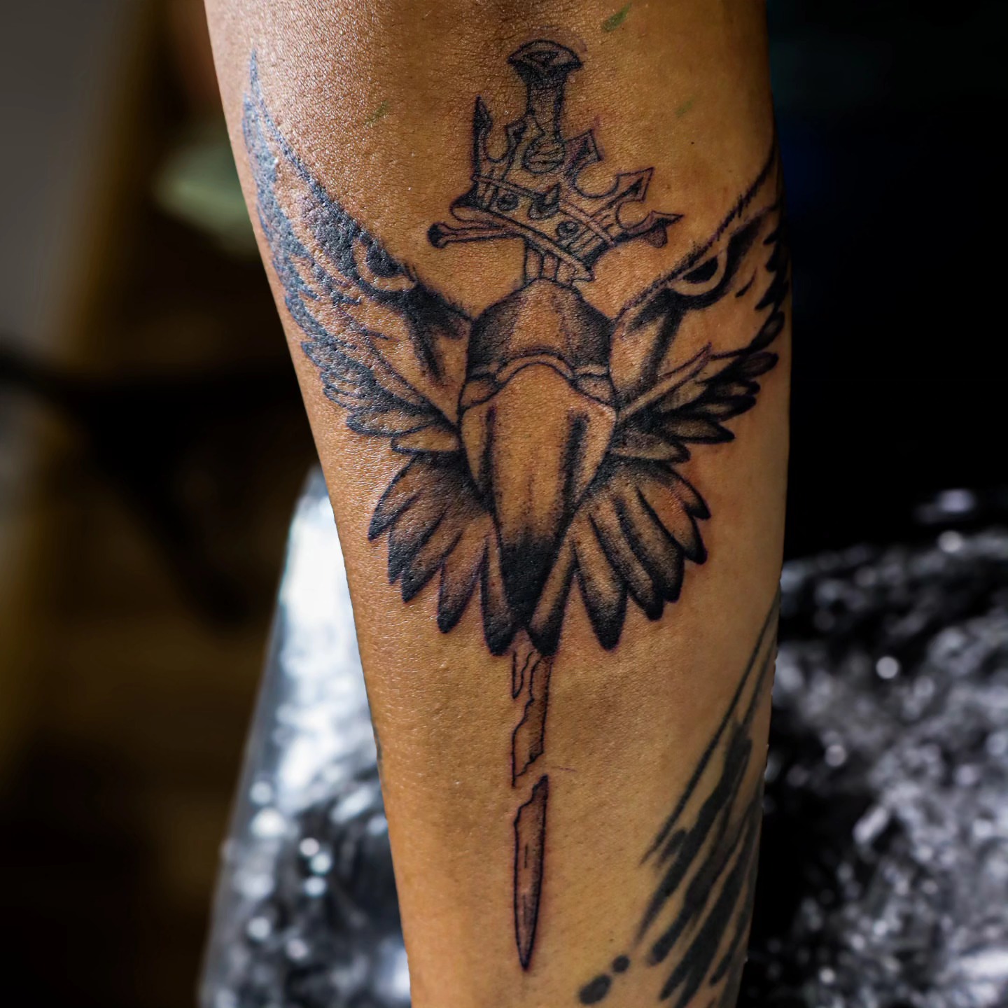 Sword with crown and eagle black and grey tattoo on the forearm by Dallas Tattoo Artist