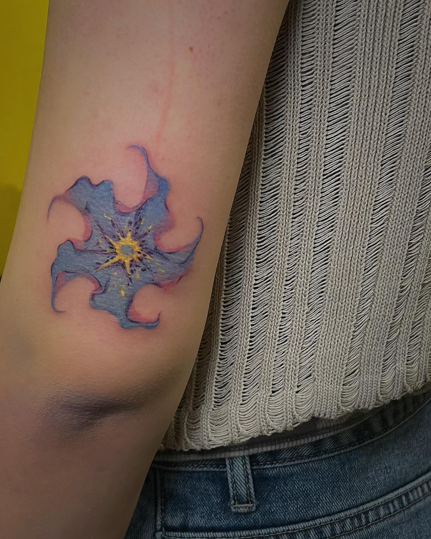Flower watercolor tattoo on the forearm by Echo