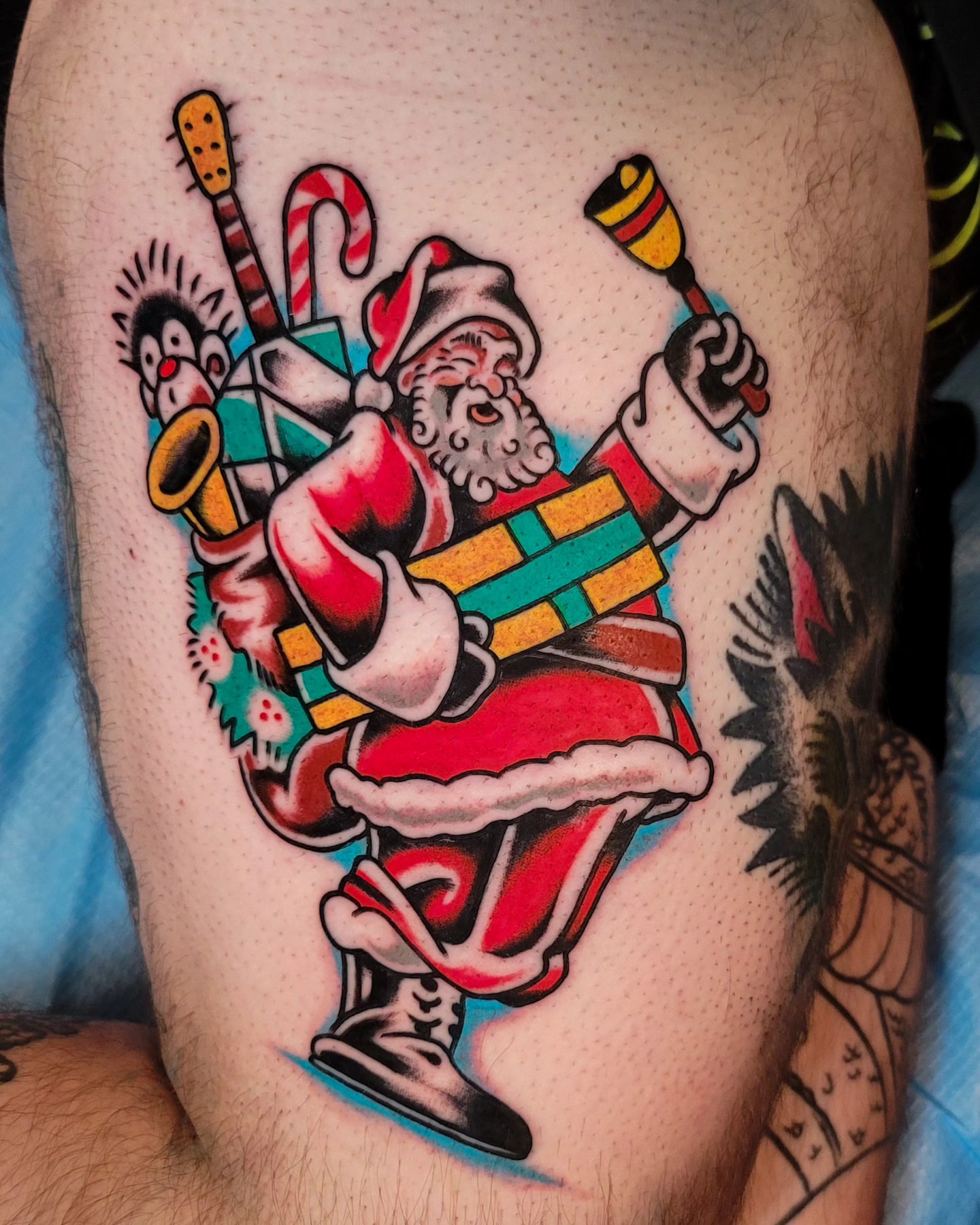 Jolly santa claus American traditional tattoo on the thigh by J. Kirsch New Jersey Tattoo Artist